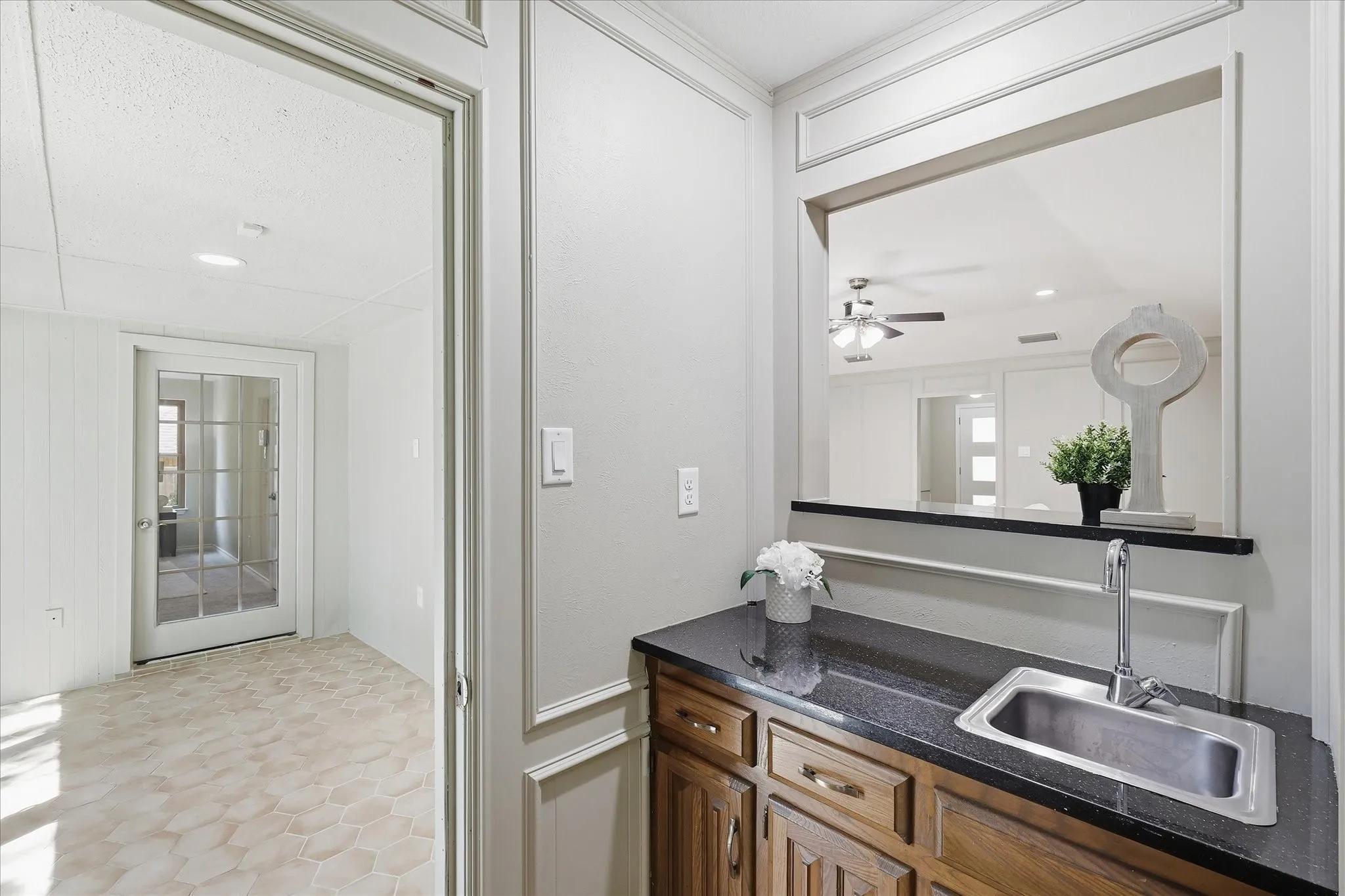 Hidden Wet Bar or use as storage located between Sunroom and back Living space