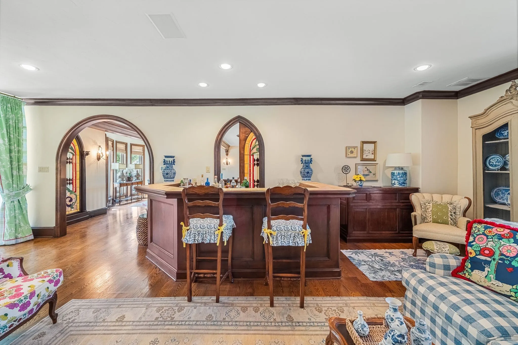 Wet bar upstairs with sliding stained glass behind the bar for access