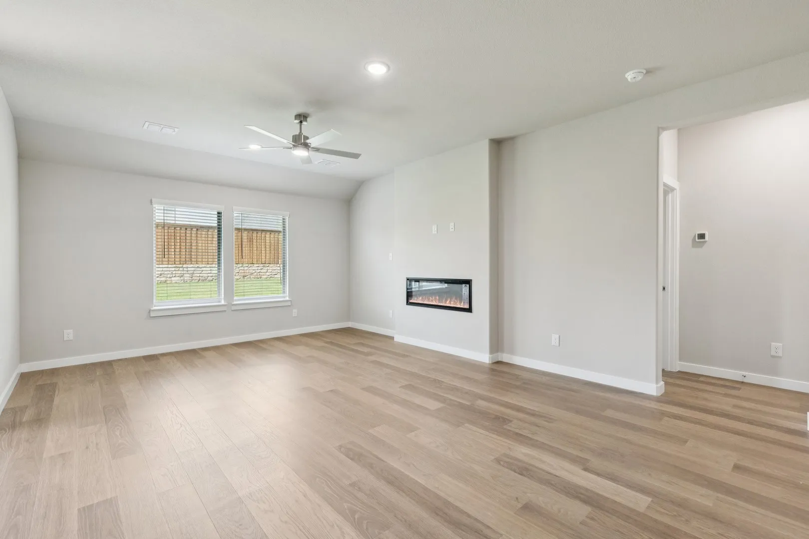 Living room in the Heisman home plan by Trophy Signature Homes – REPRESENTATIVE PHOTO