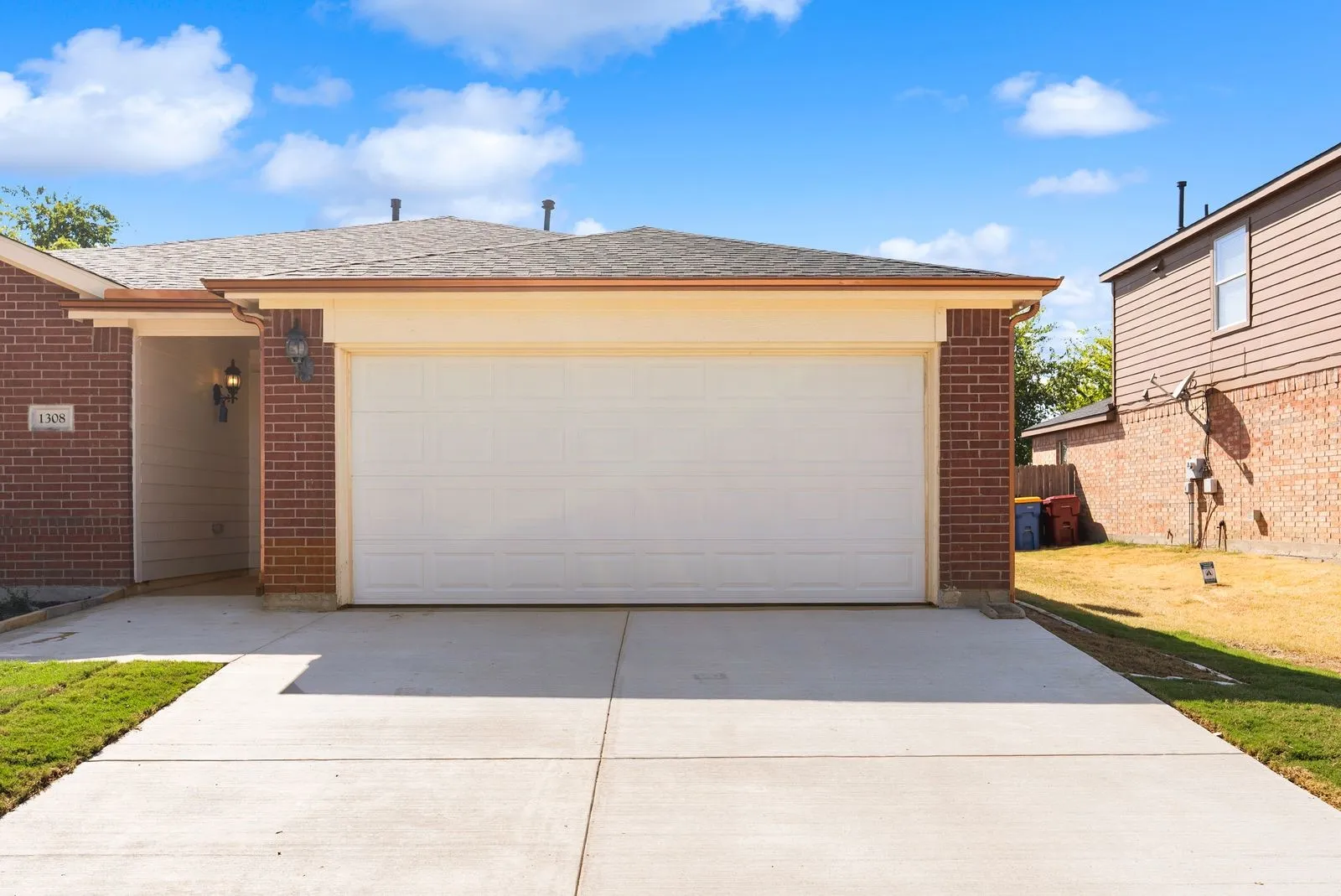 Brick exterior with a single-car garage and concrete driveway
