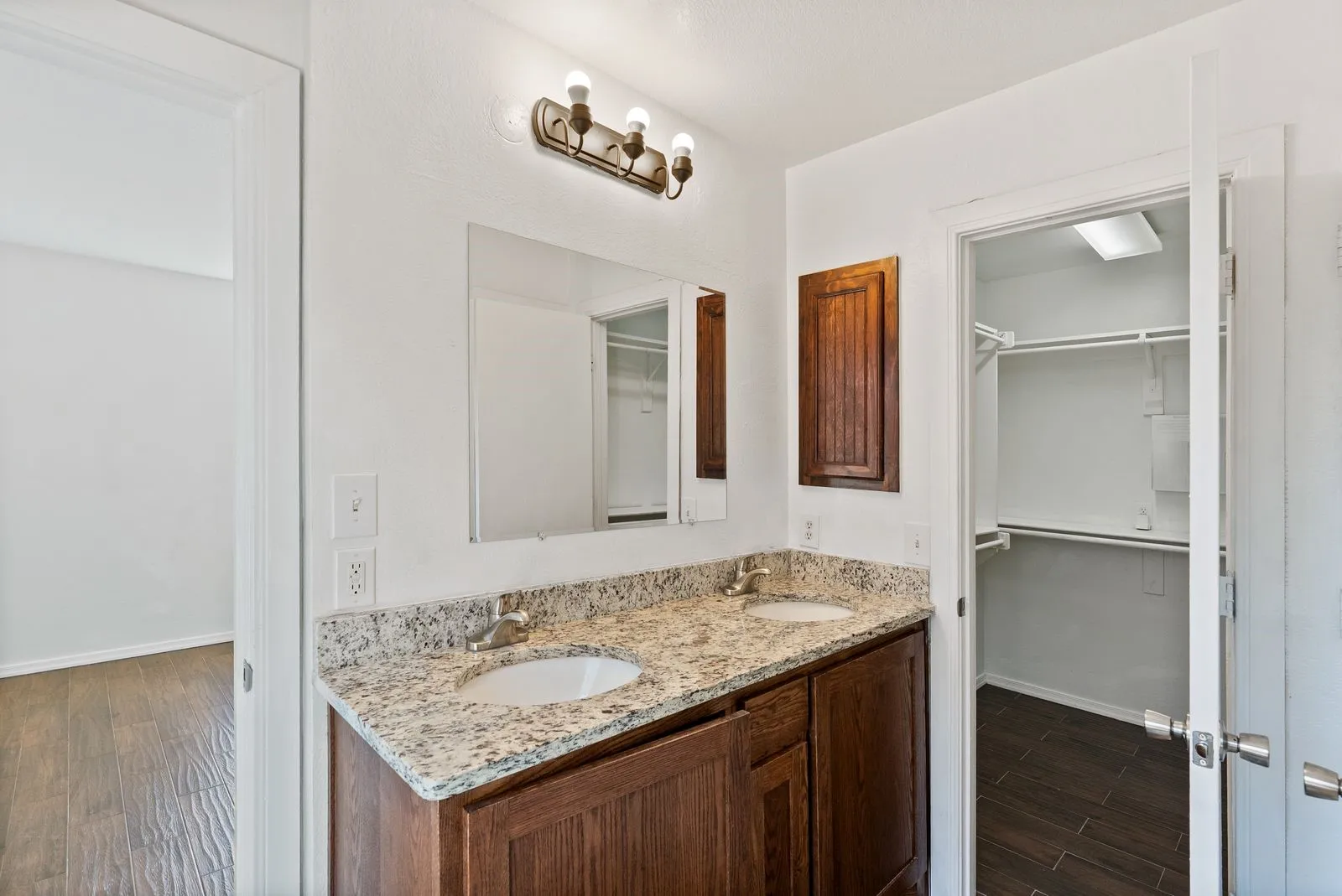 Dual vanity with integrated sinks and a stone-finish countertop