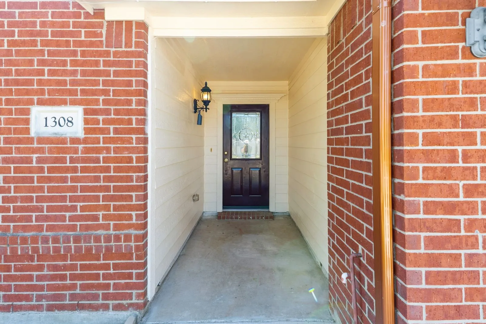 Brick exterior with siding accents and a recessed entry