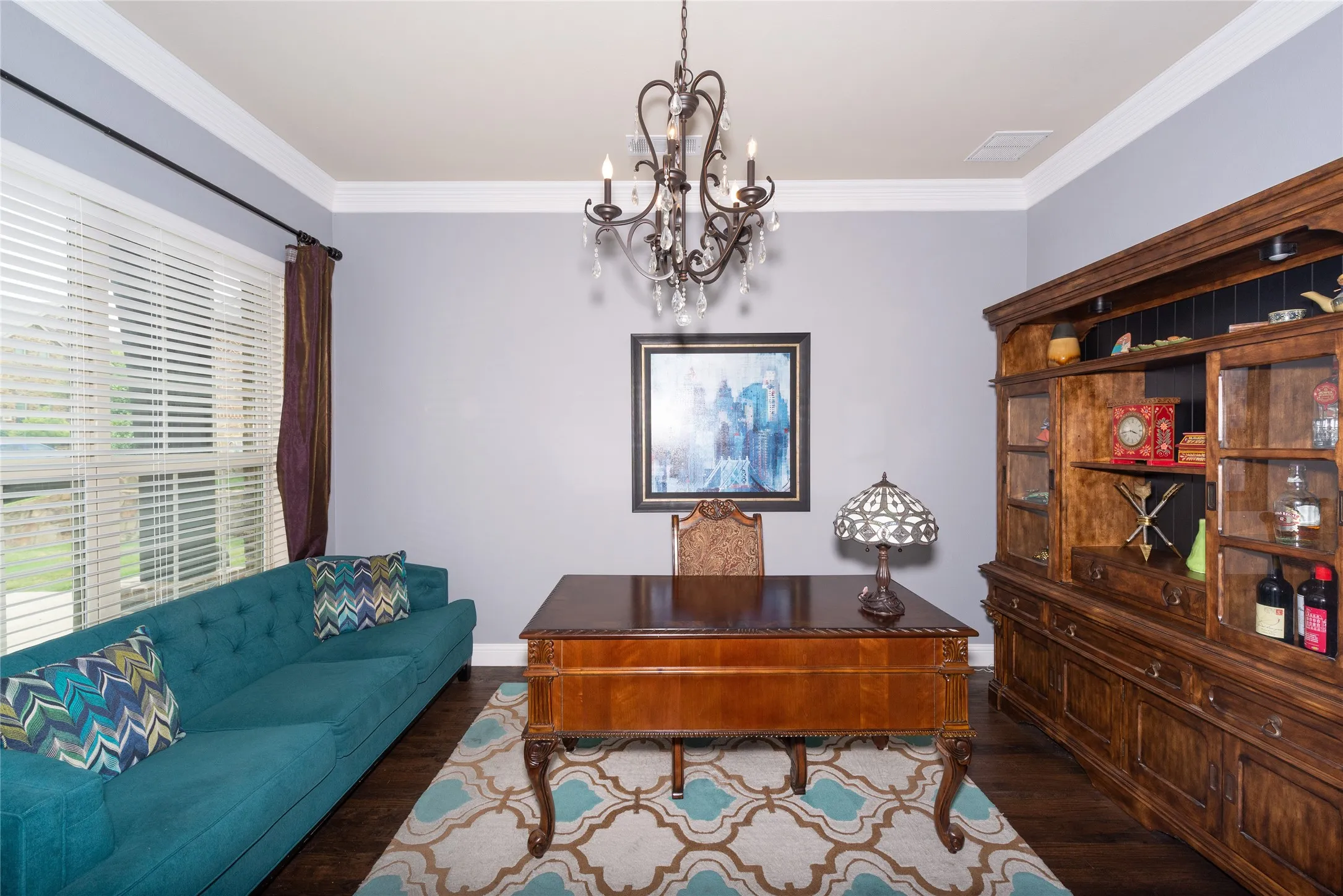 Crown molding, wood-finish flooring, and chandelier