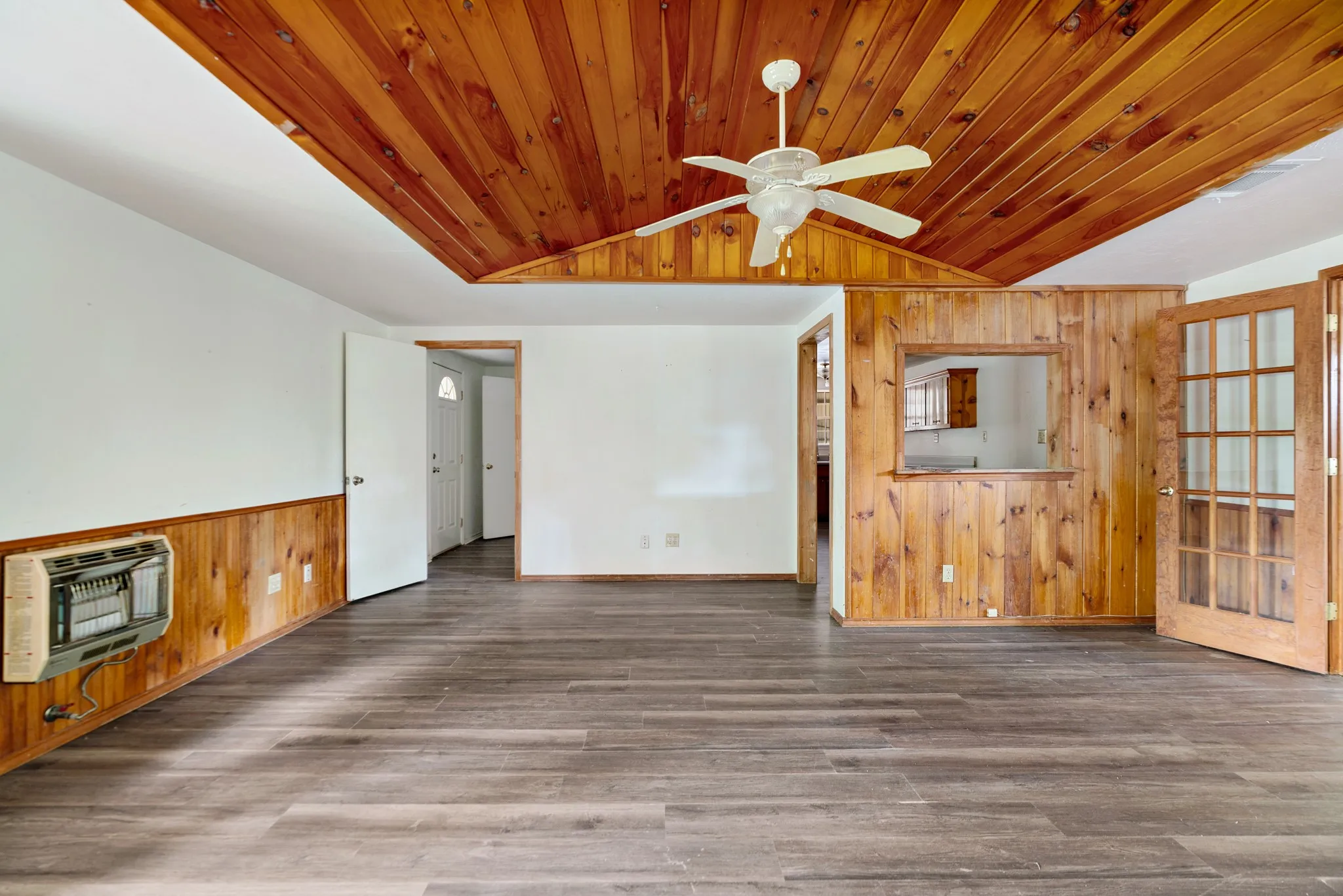 Character-filled living space with warm wood ceiling detail