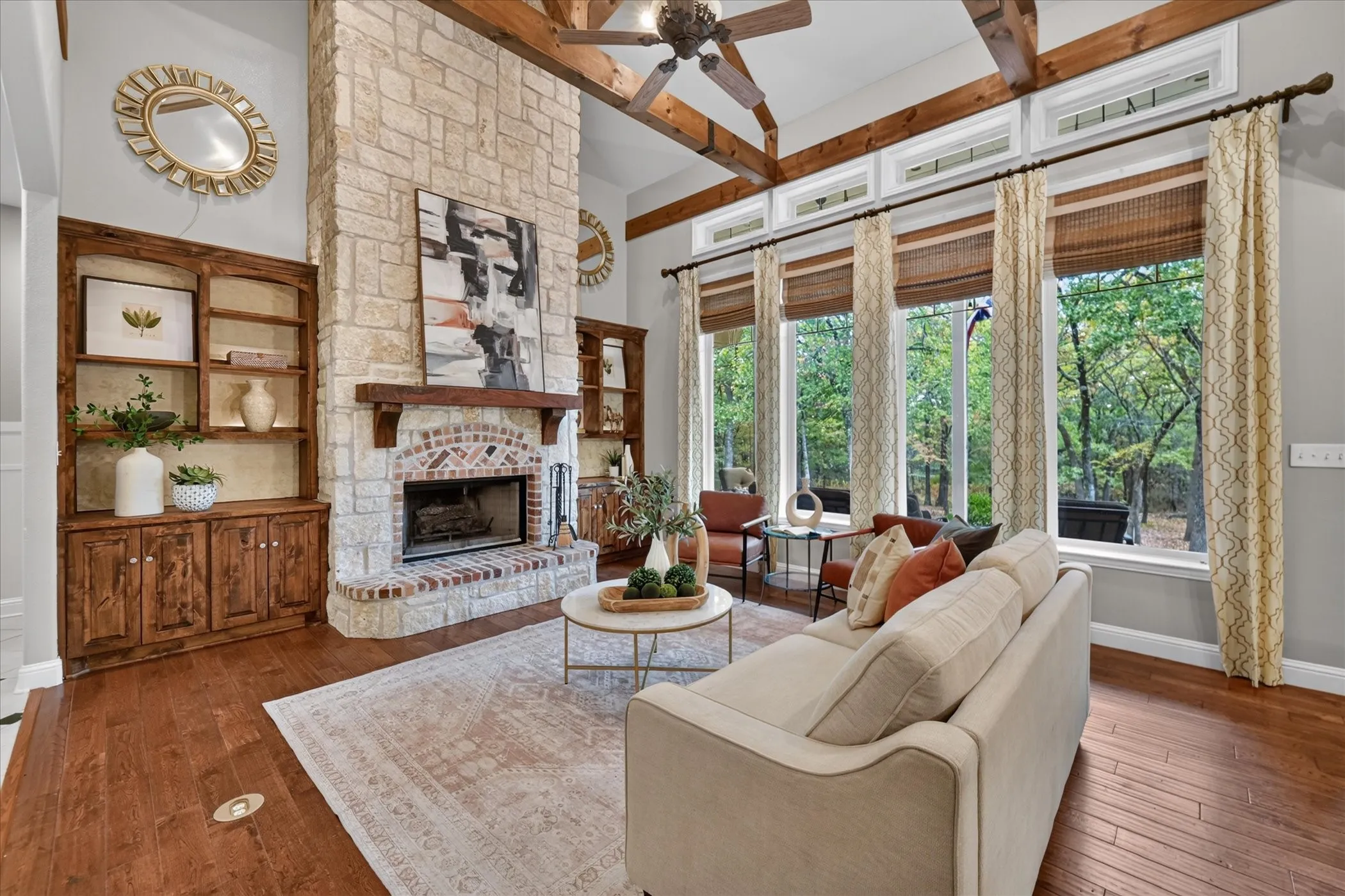 Stone-clad fireplace with a brick hearth and wood mantel