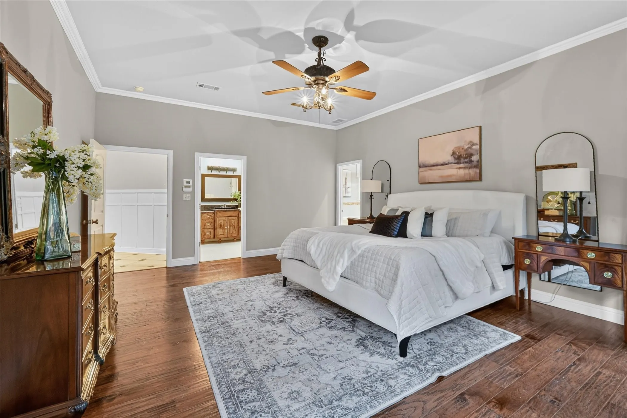 Hardwood-finish flooring and vaulted ceiling with a decorative ceiling fan