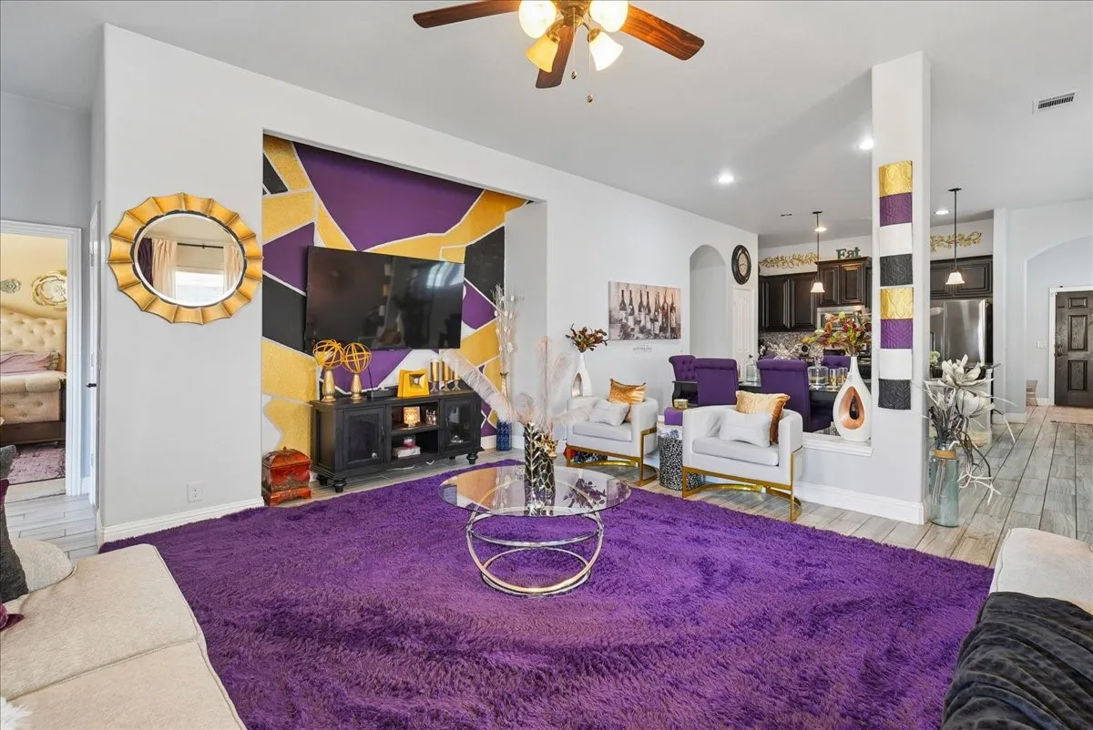 Open concept living area featuring a ceiling fan, recessed lighting, and wood-finish flooring