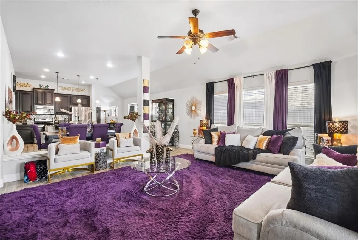Vaulted ceilings, recessed lighting, ceiling fan, and multiple windows with blinds