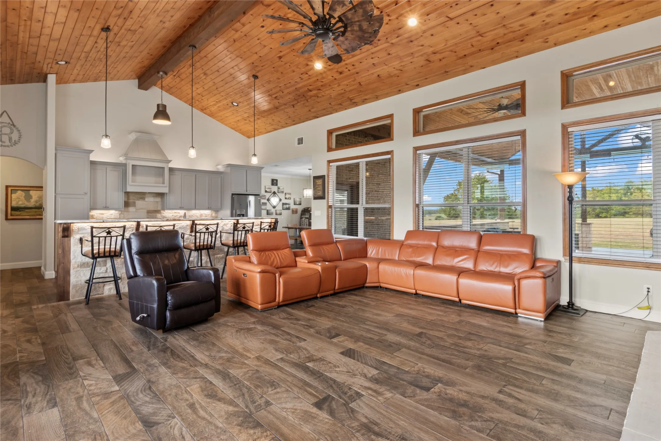 Living room with wall of windows overlooking 2 acres on a hill
