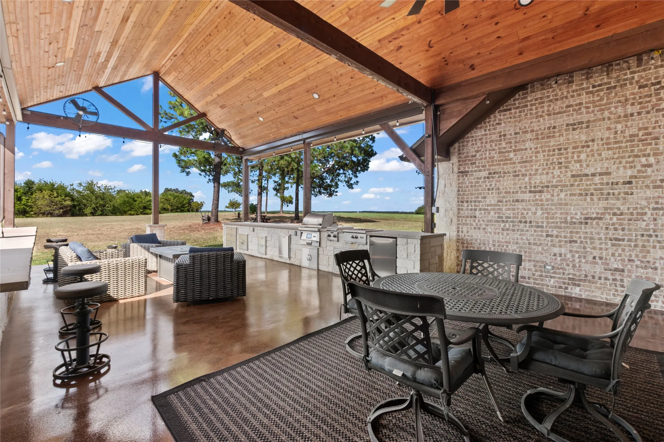 covered back patio with large outdoor kitchen
