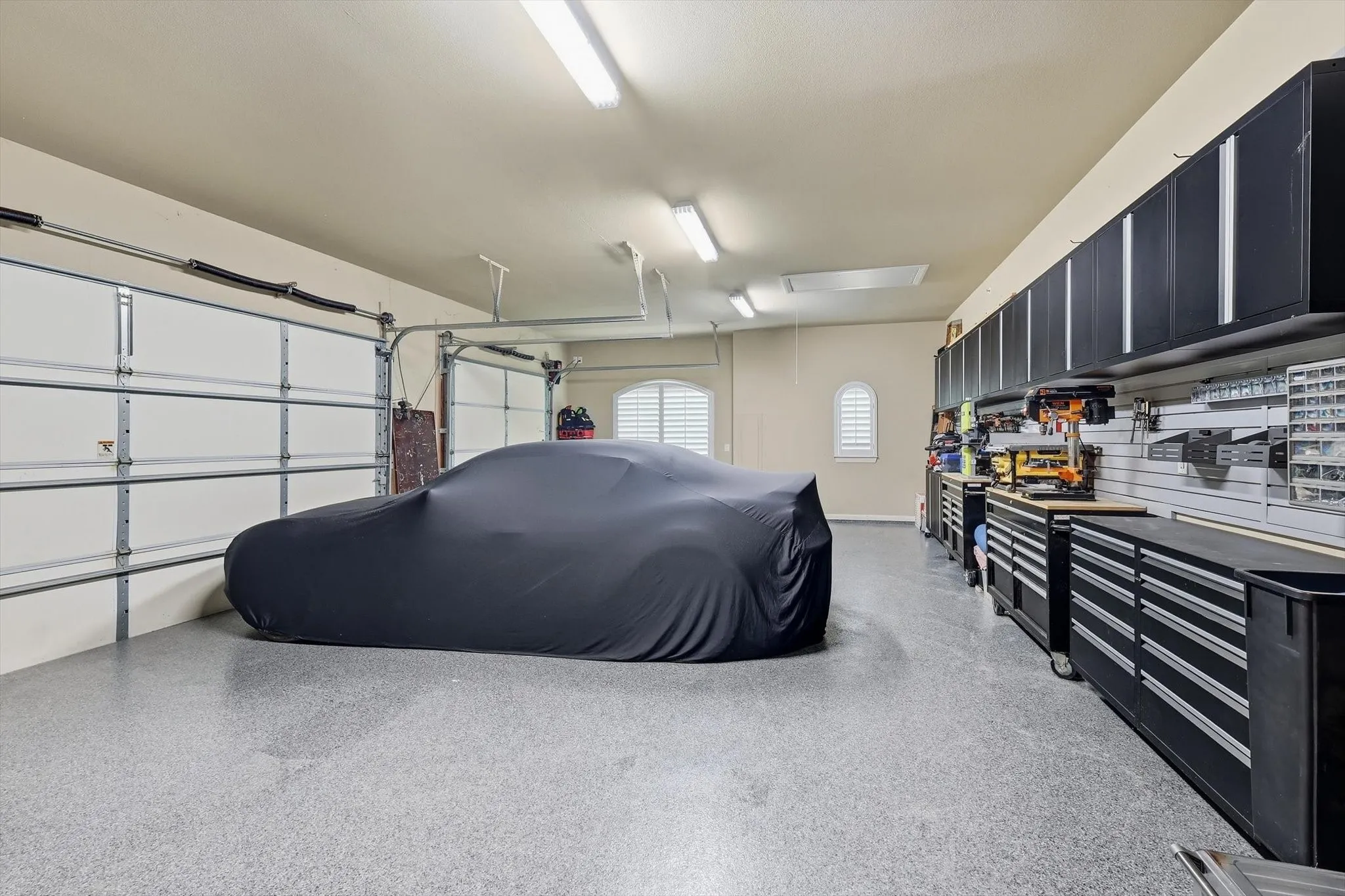 3 car garage.All garages finished off by Garage Living, with design, craftmanship & functionality: Floortex floors and high-end steel cabinets and workspaces. 4th car garage separate