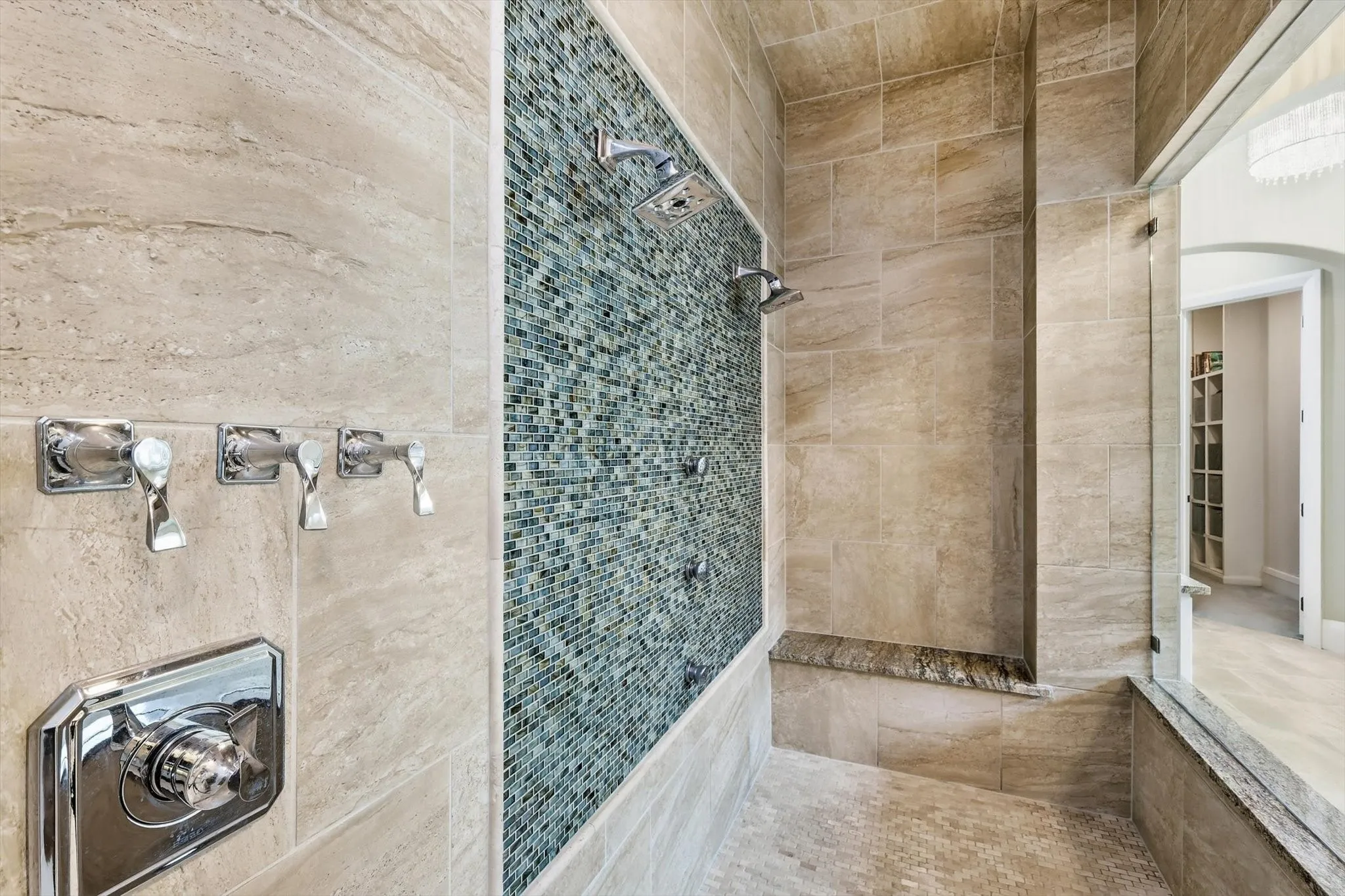 Luxurious shower area with rain shower head, 2 additional heads on wall and 3 body sprays