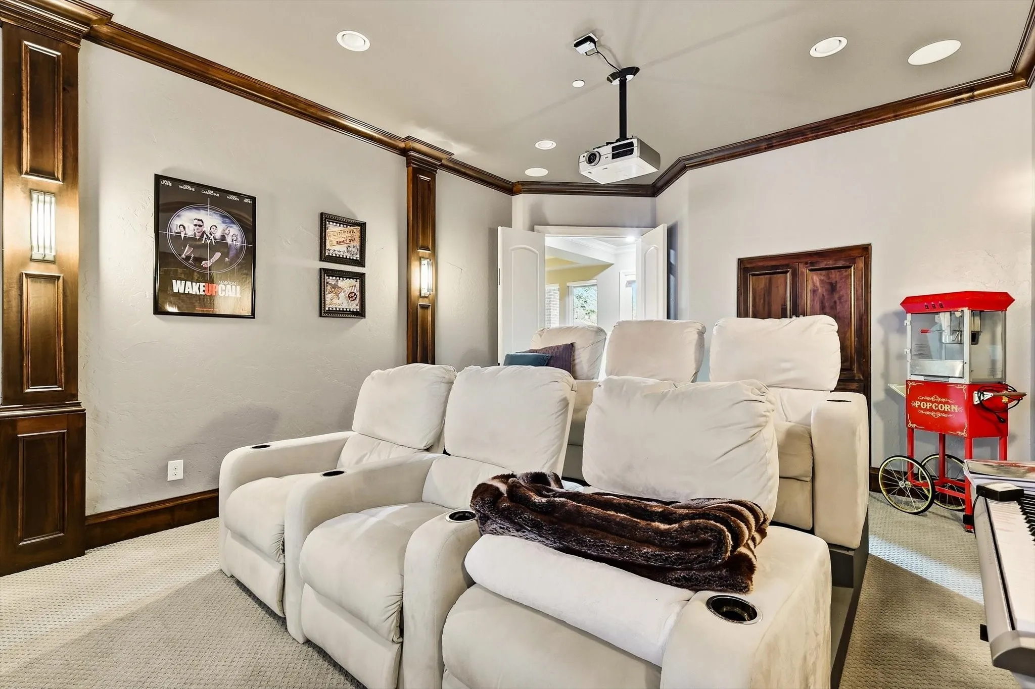 Media room on main floor. Enhanced with hardwood pilasters and crown moldingsMedia room on main floor. Enhanced with hardwood pilasters and crown moldings