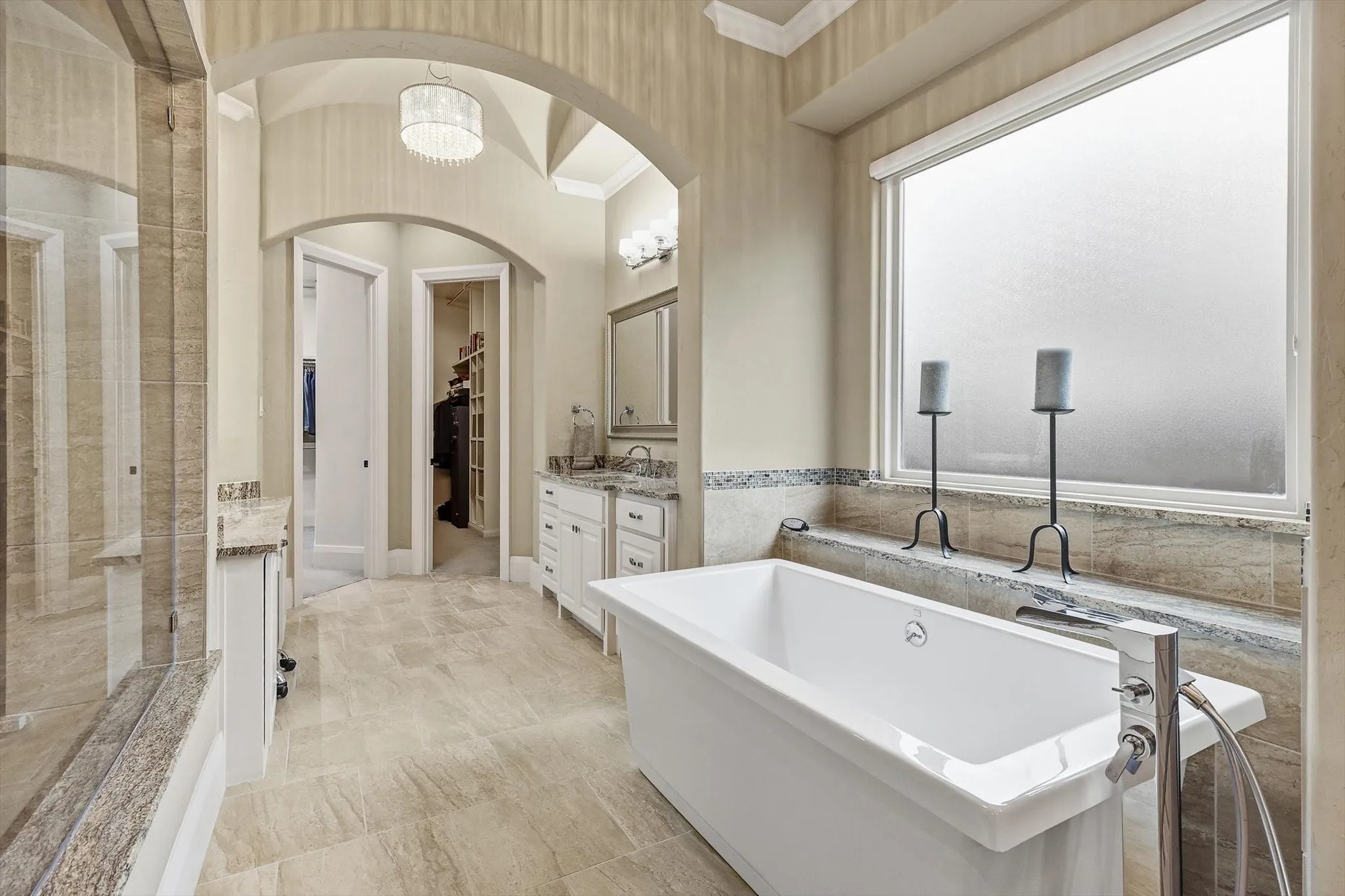 And a close up of the Tub area and vanity areas defined by repeating rib vault and multiple chandeliers