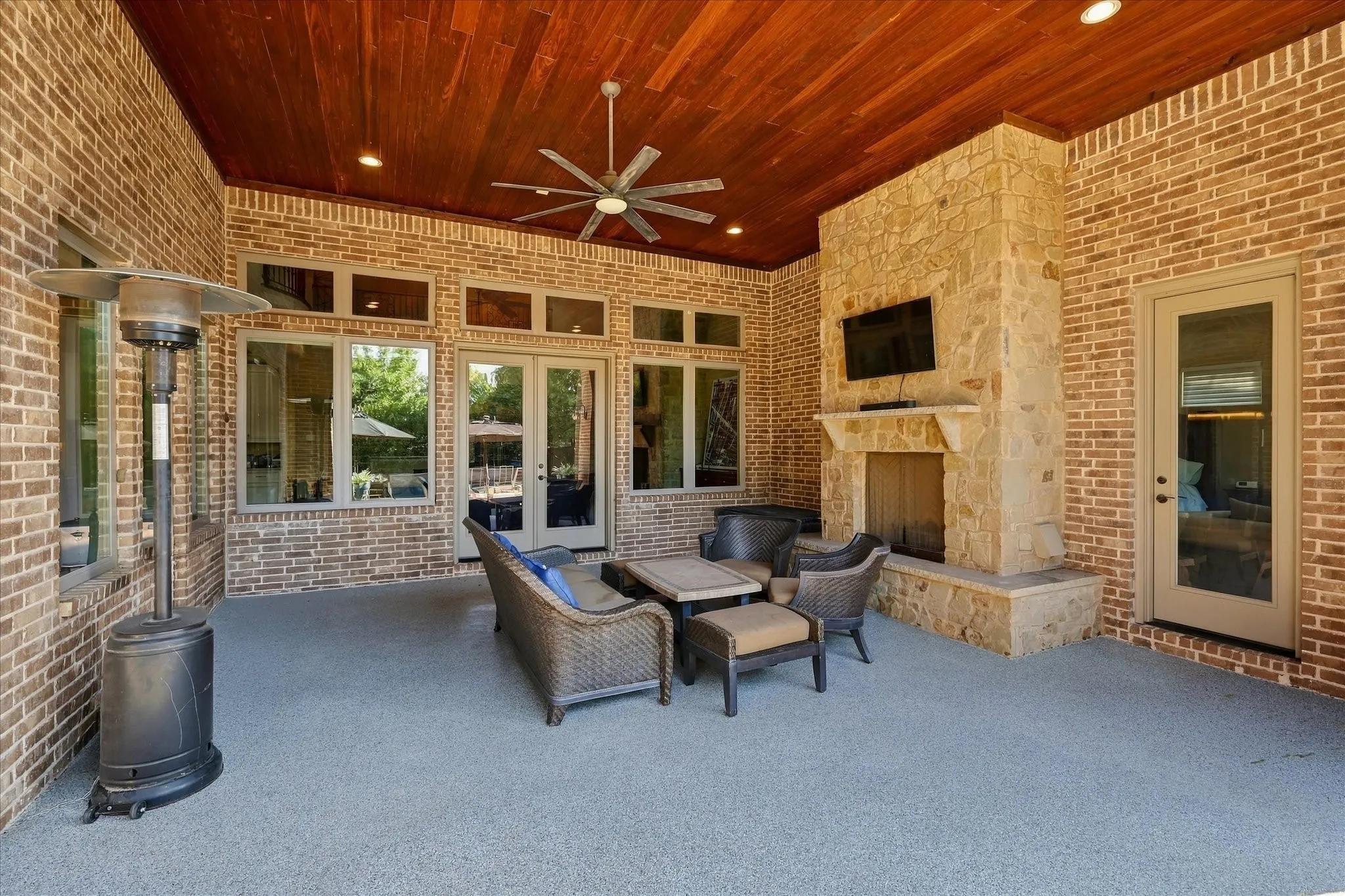 Stone gas fireplace. And a view of the inside of the home from the outside.