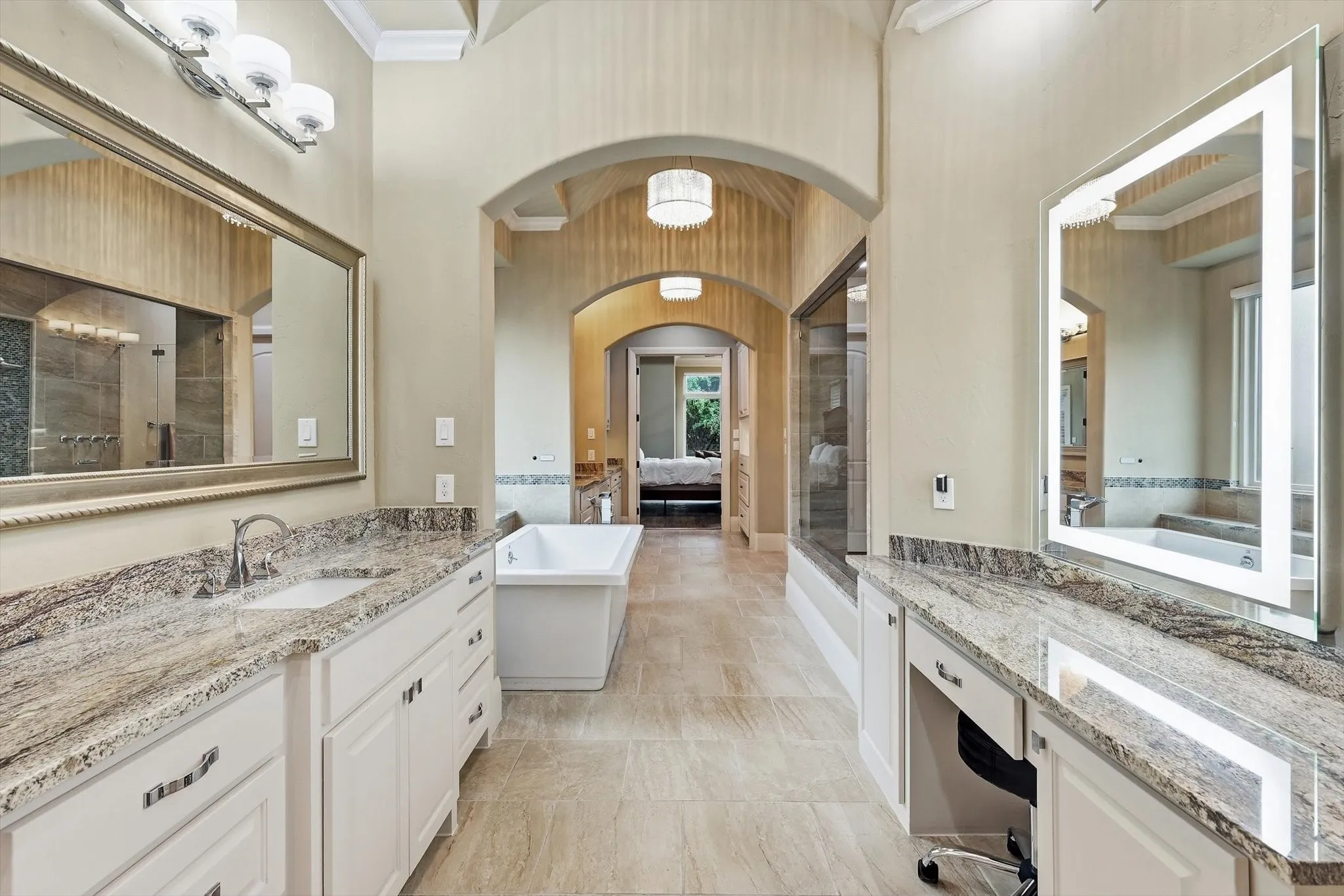 Large counter space, light granite, decorative lighting and huge mirrors