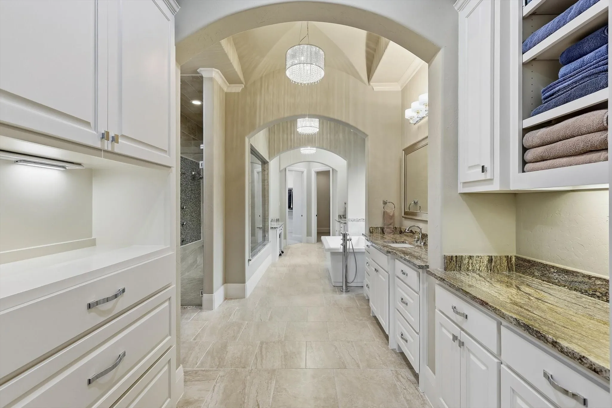 The primary bath. 3 separate areas, one a sitting area and then dual vanities and a free standing tub