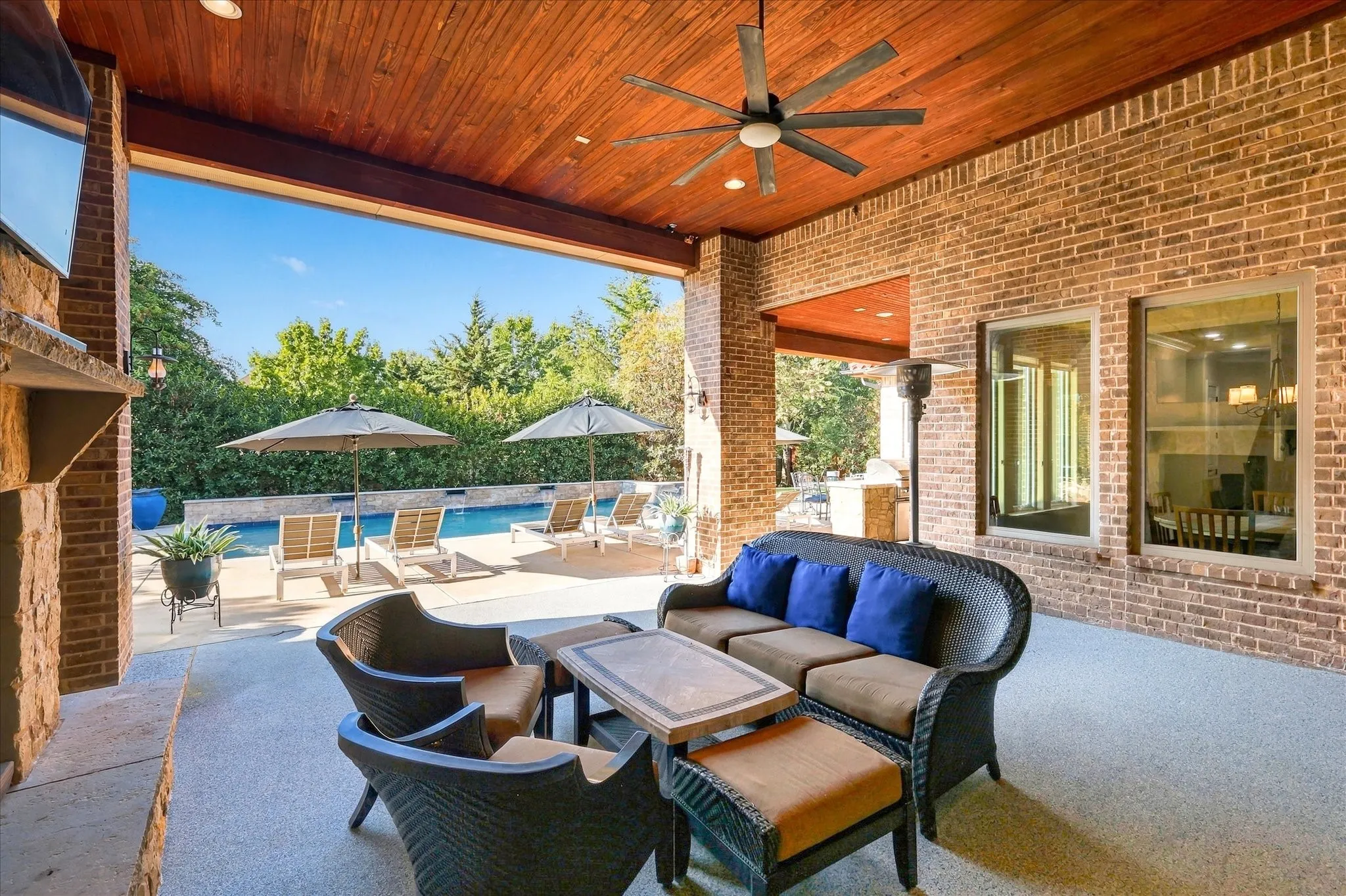 Covered back patio. Rich wood ceiling, can lights , fan and a fabulous view of the pool area and landscaping.