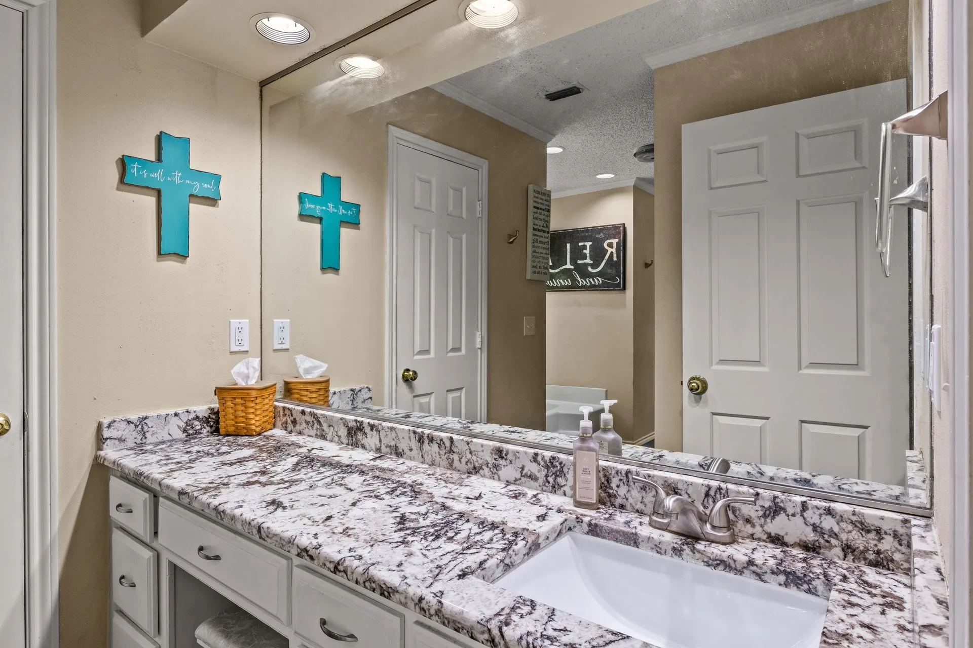 Bathroom featuring vanity, ornamental molding, and a textured ceiling