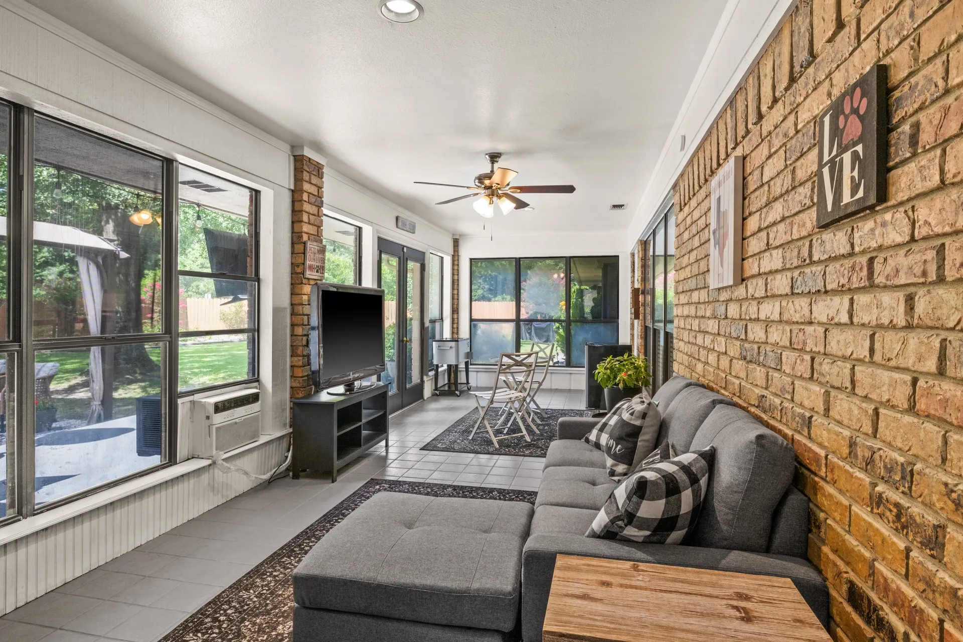 Sunroom / solarium with a ceiling fan and plenty of natural light
