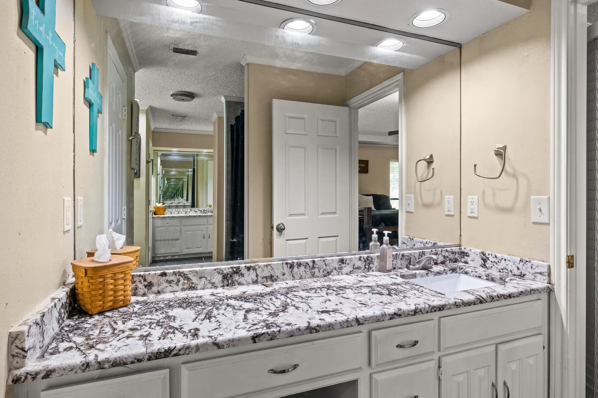 Full bathroom featuring vanity, ornamental molding, and a textured ceiling