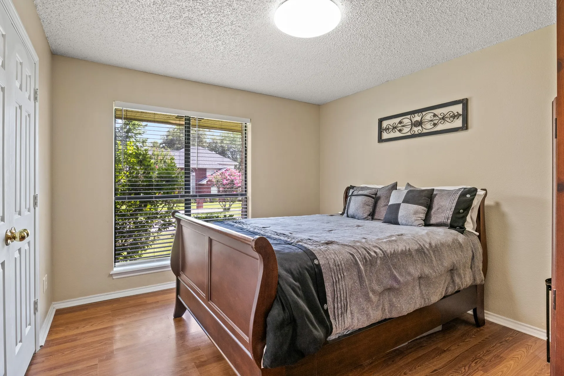 Bedroom featuring wood finished floors and a textured ceiling