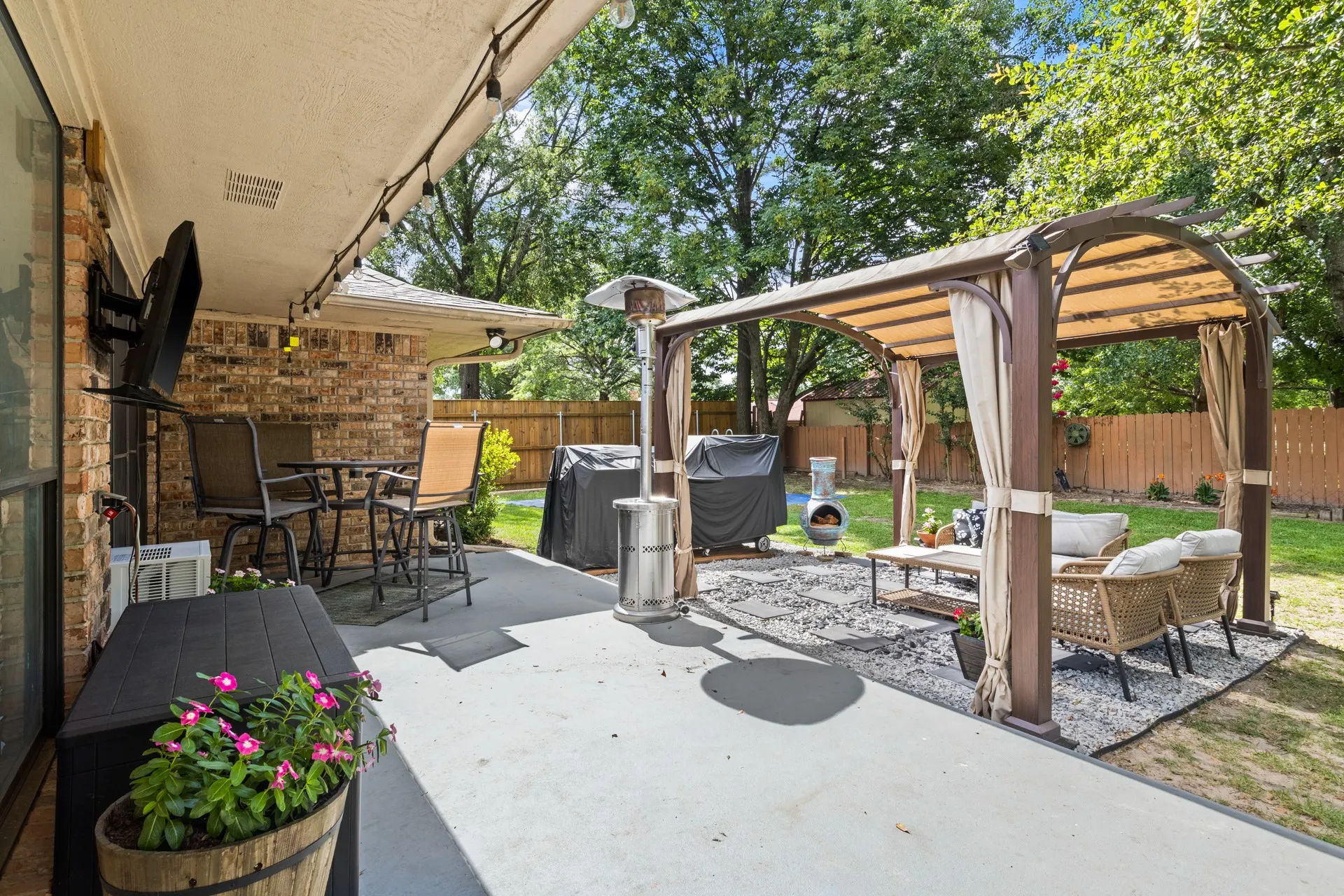 Fenced backyard featuring a patio and an outdoor hangout area