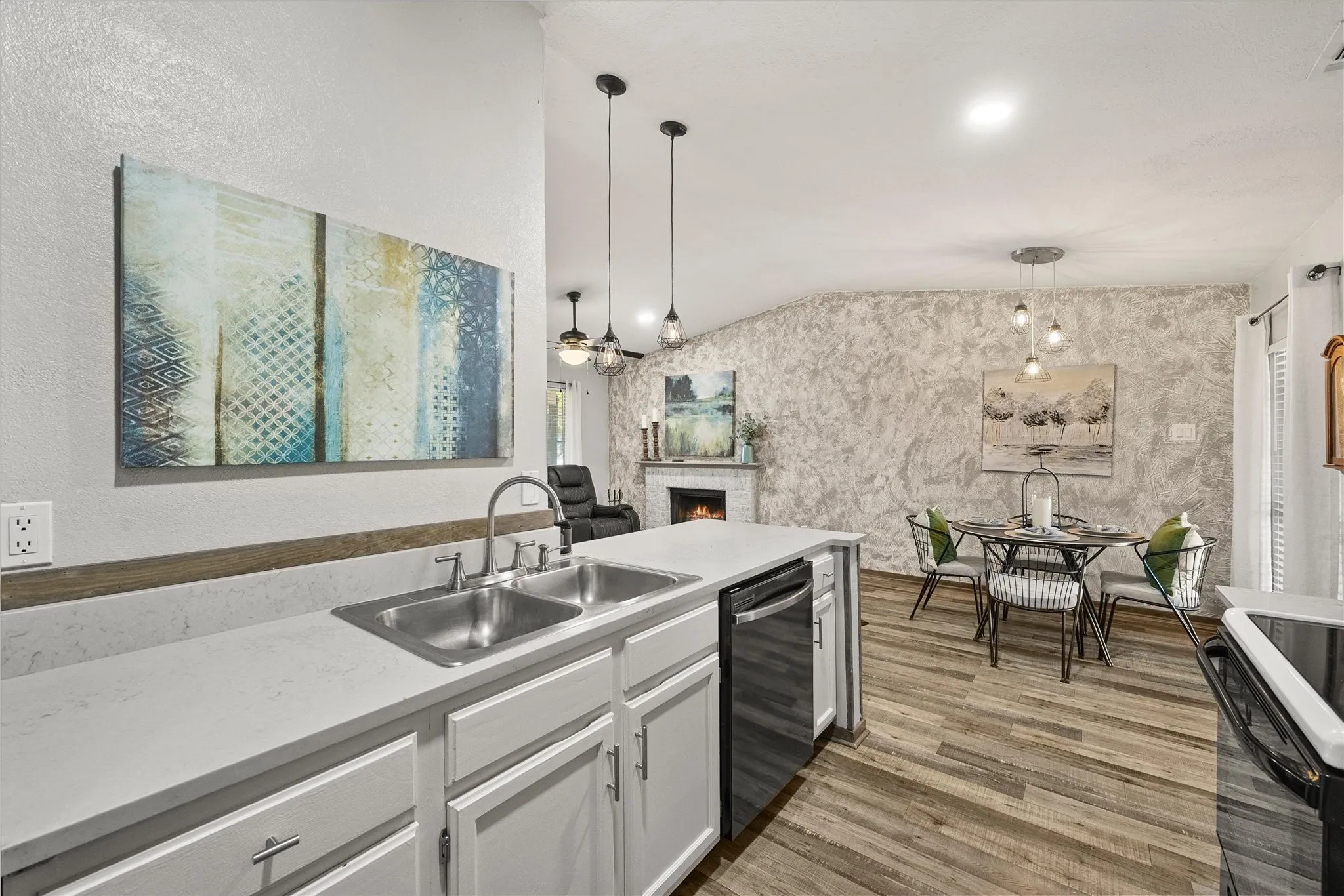 Kitchen island featuring a dual-basin stainless steel sink and a built-in dishwasher