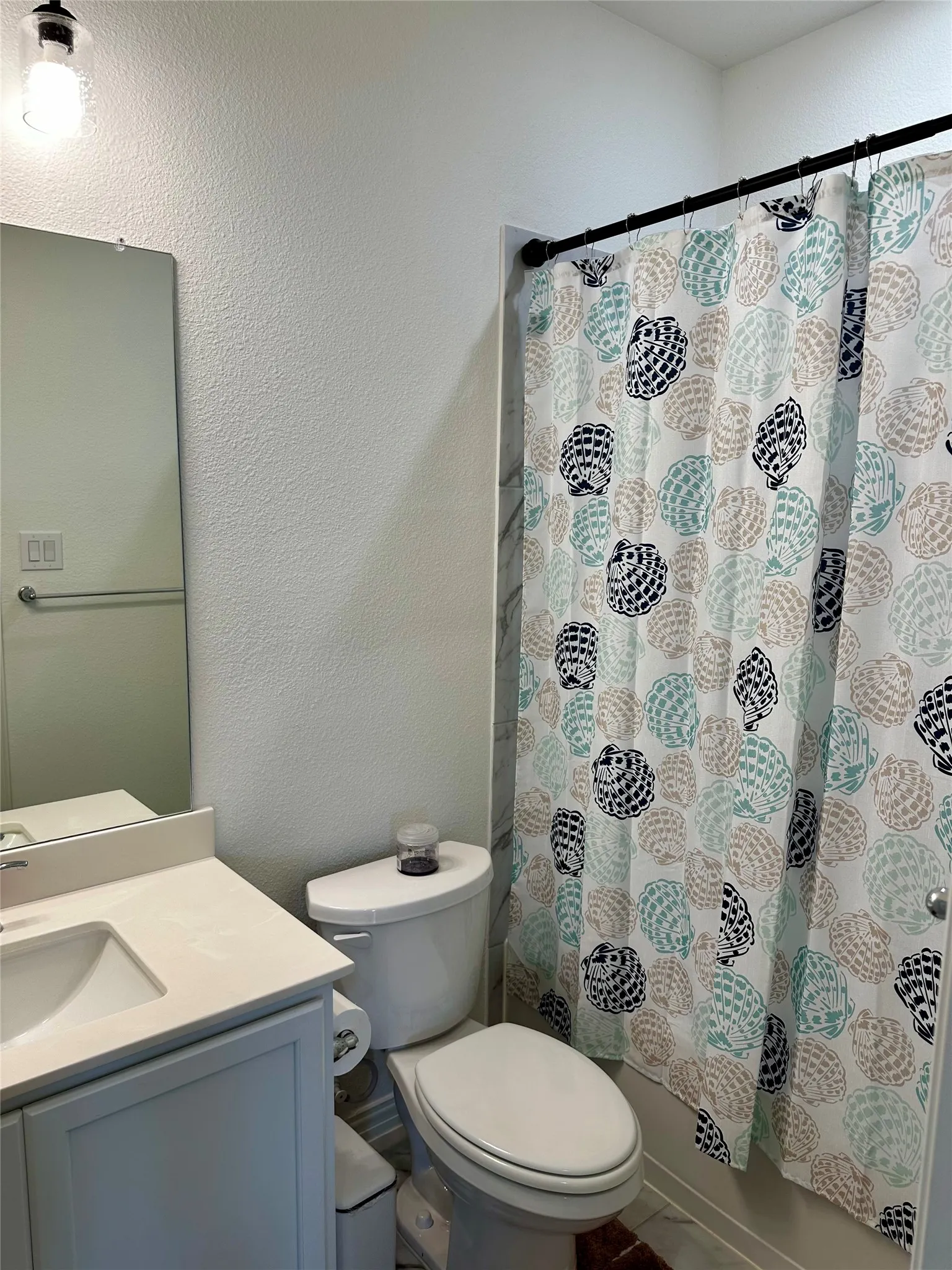 White vanity with an integrated sink, polished chrome faucet, and a wall-mounted mirror