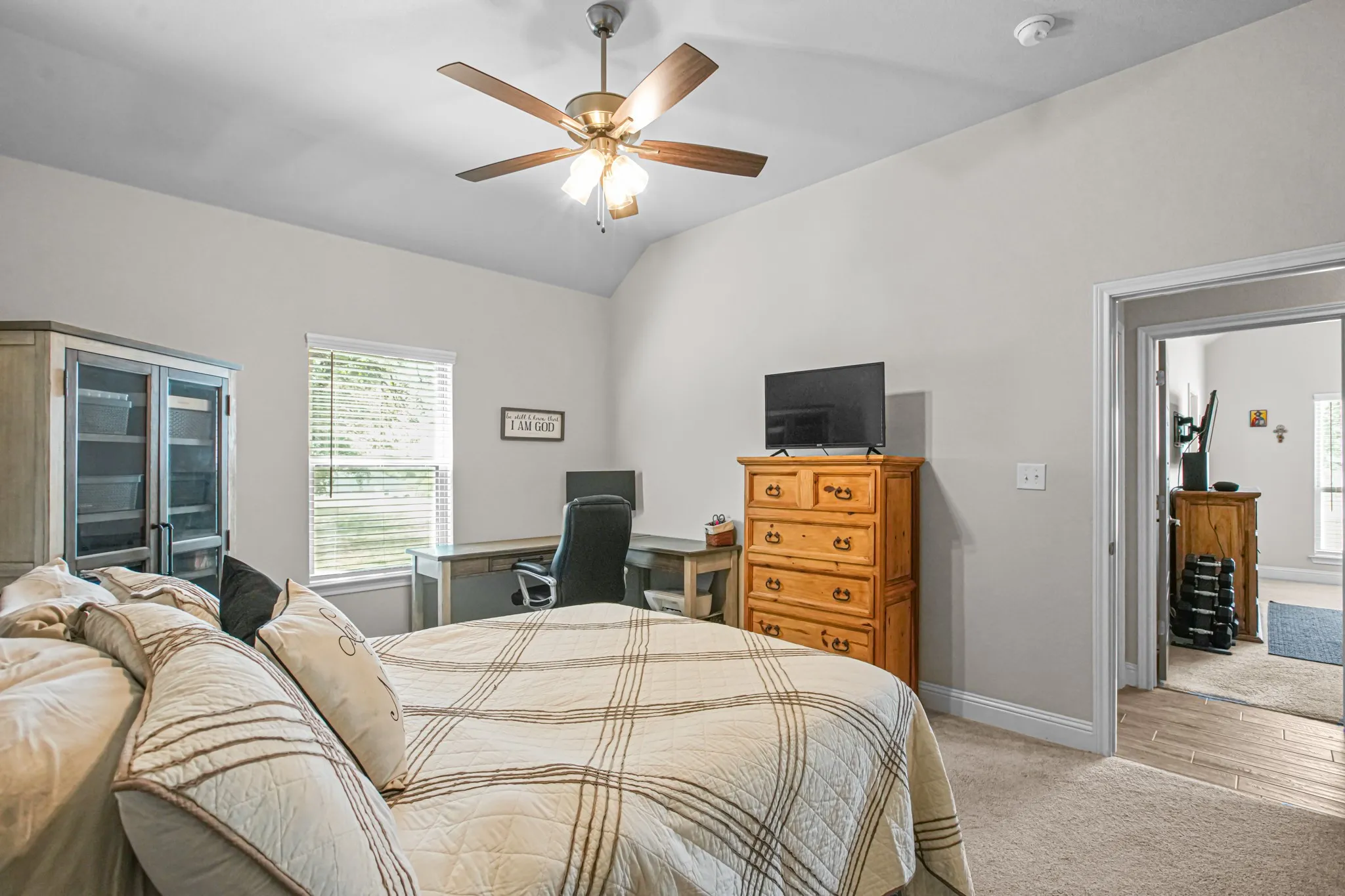 Vaulted ceiling with a ceiling fan, recessed window, and carpet flooring