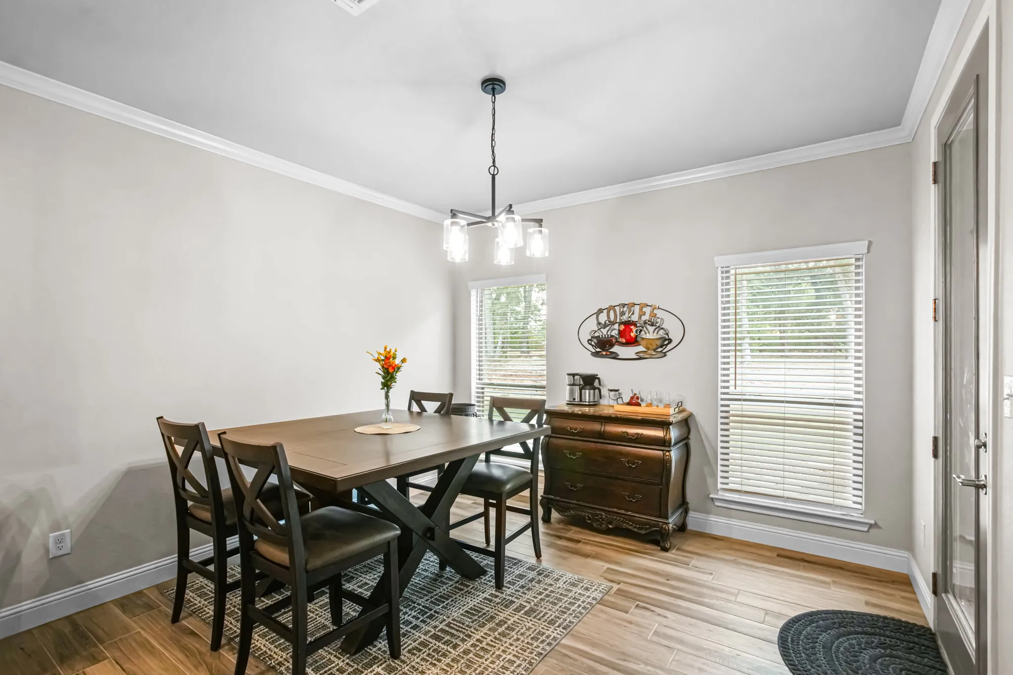 Recessed lighting, wood-finish flooring, crown molding, and a chandelier fixture