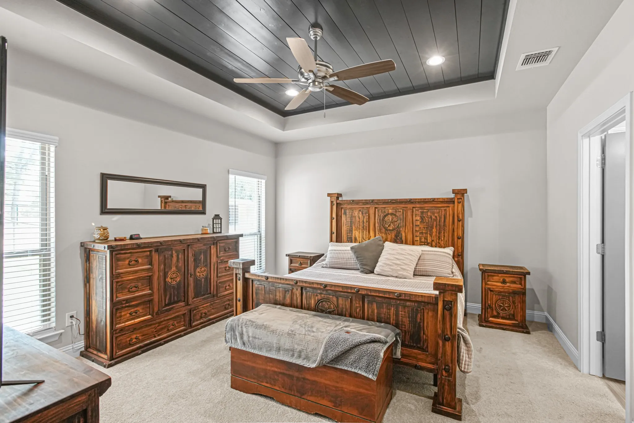 Tray ceiling featuring dark wood-finish planking and recessed lighting