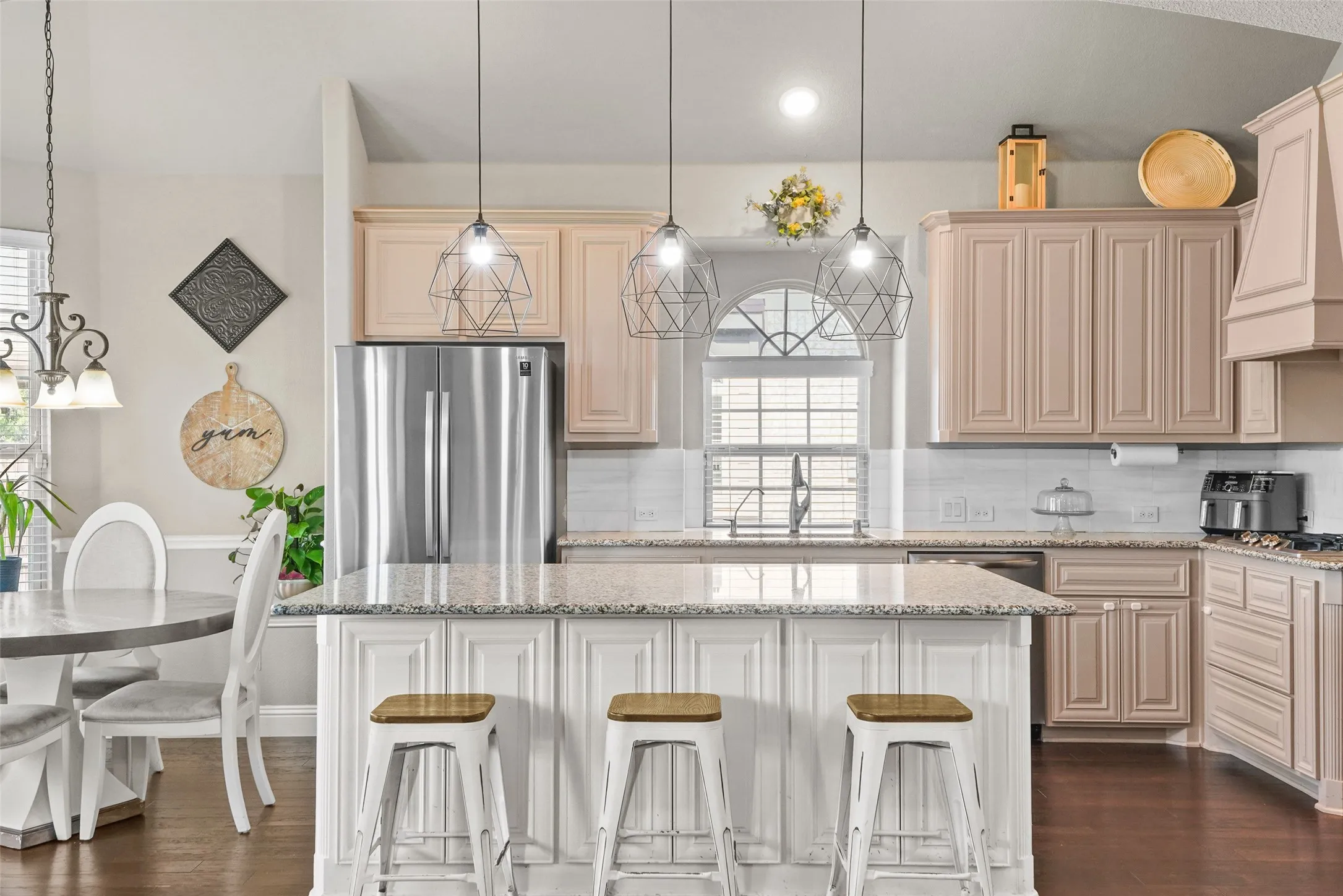 Kitchen with a central island featuring a granite countertop and paneled base