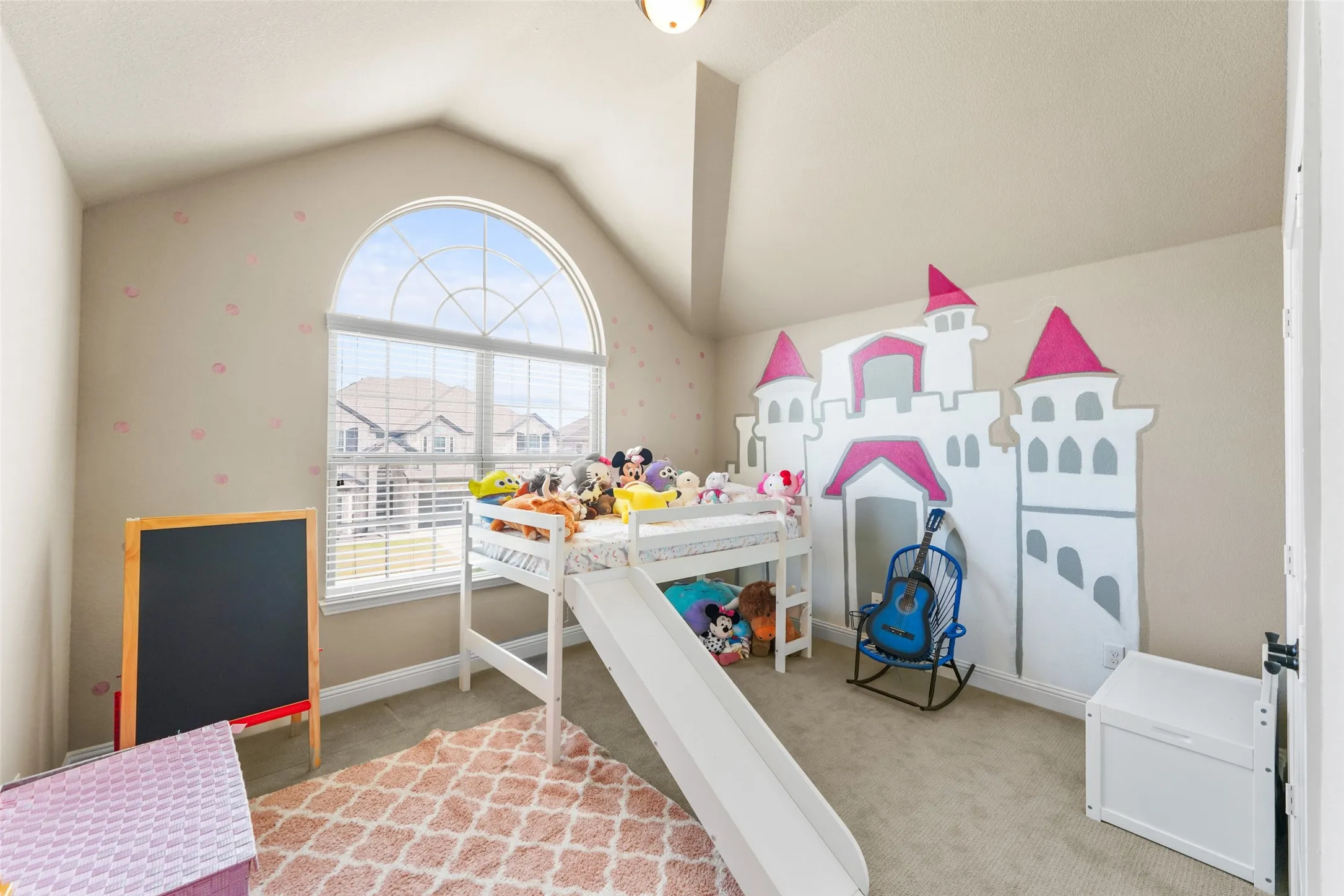 Vaulted ceiling with an arched window, featuring blinds for light control