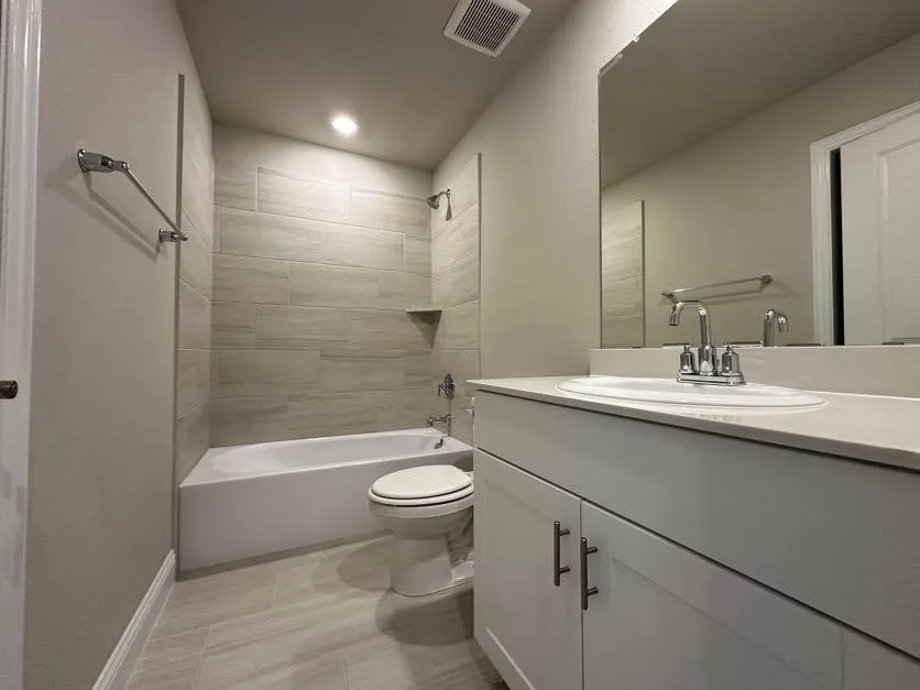 White vanity with brushed nickel hardware and integrated sink