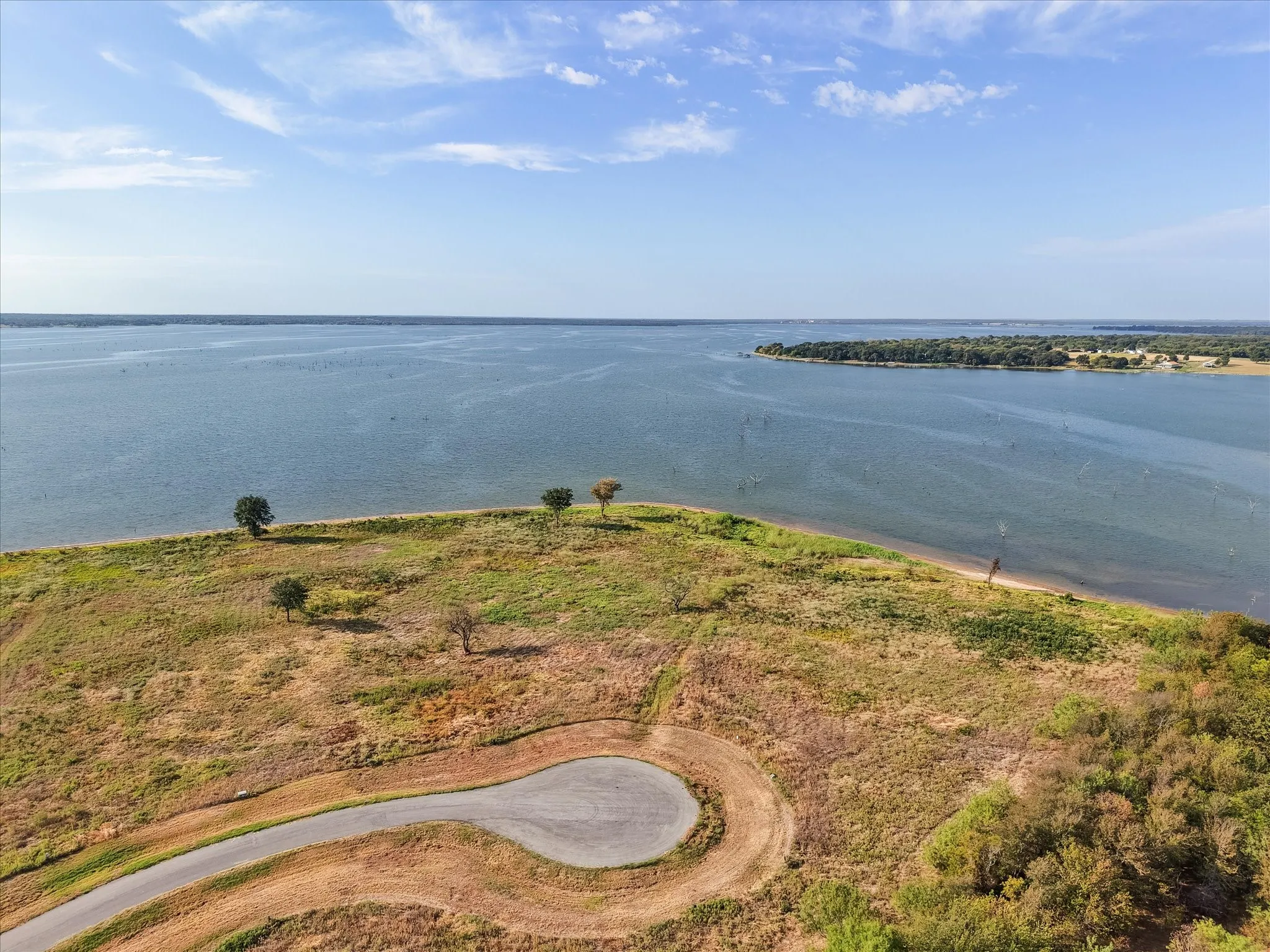 Expansive waterfront property featuring a paved cul-de-sac