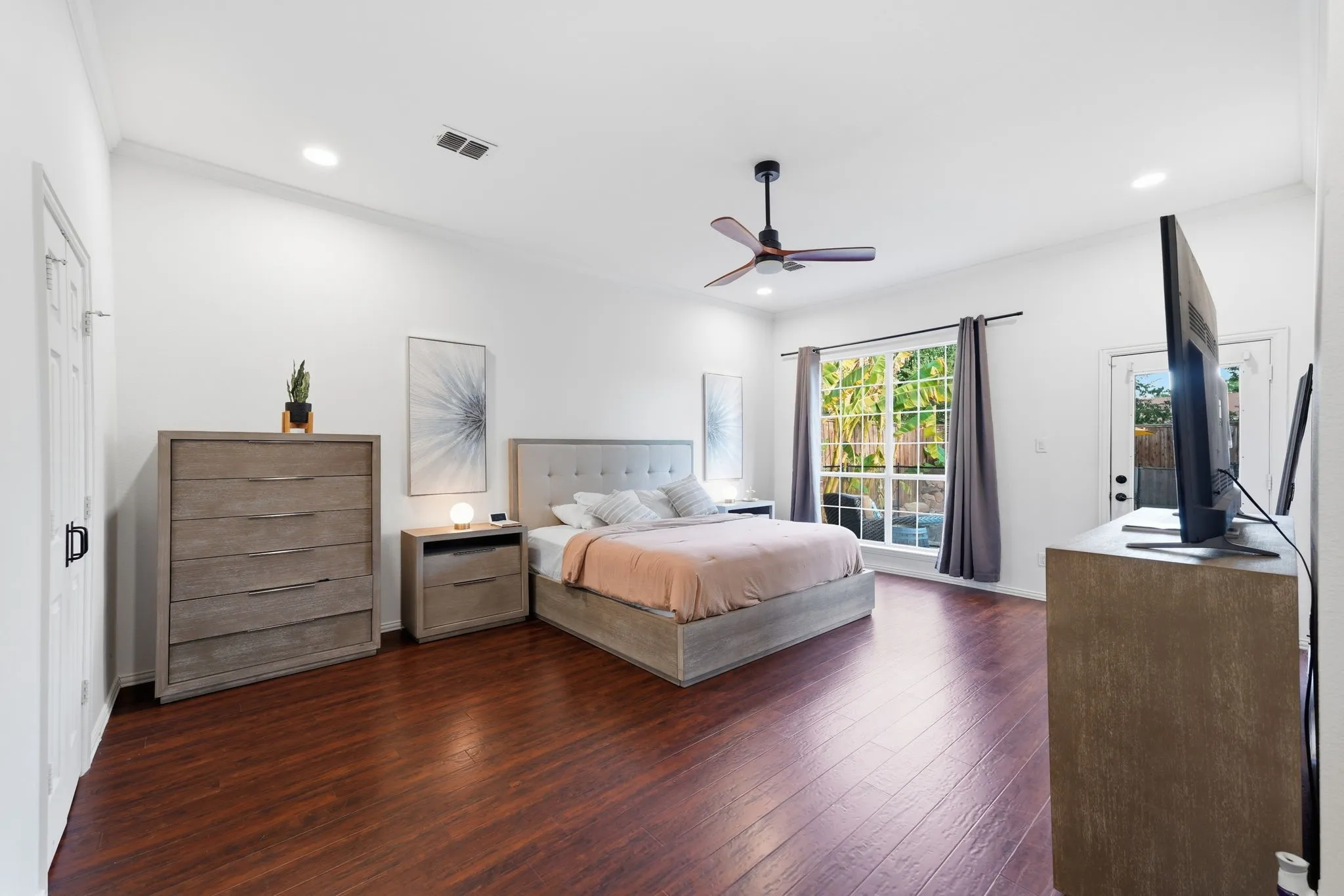 Primary Bedroom, downstairs, walk-in-closet. Door to backyard.