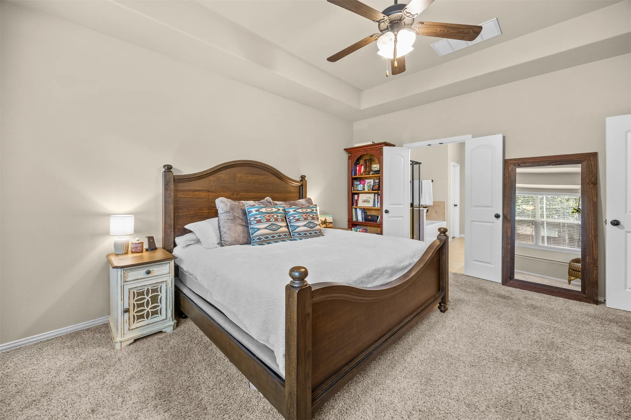 Private first-floor primary suite with generous proportions, ensuite bath and walk-in closet