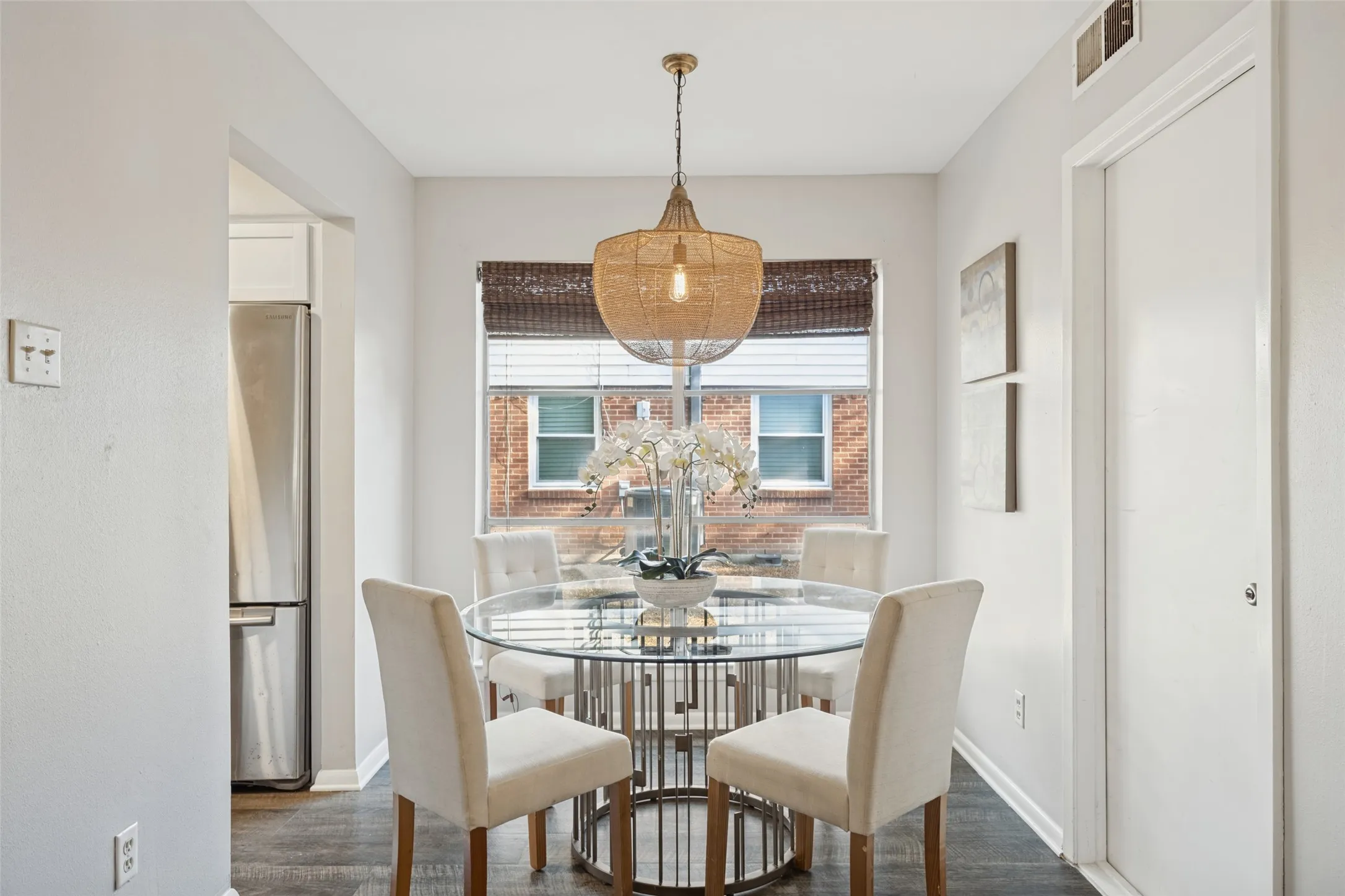 Window with horizontal blinds, built-in ceiling light, and wood-finish flooring