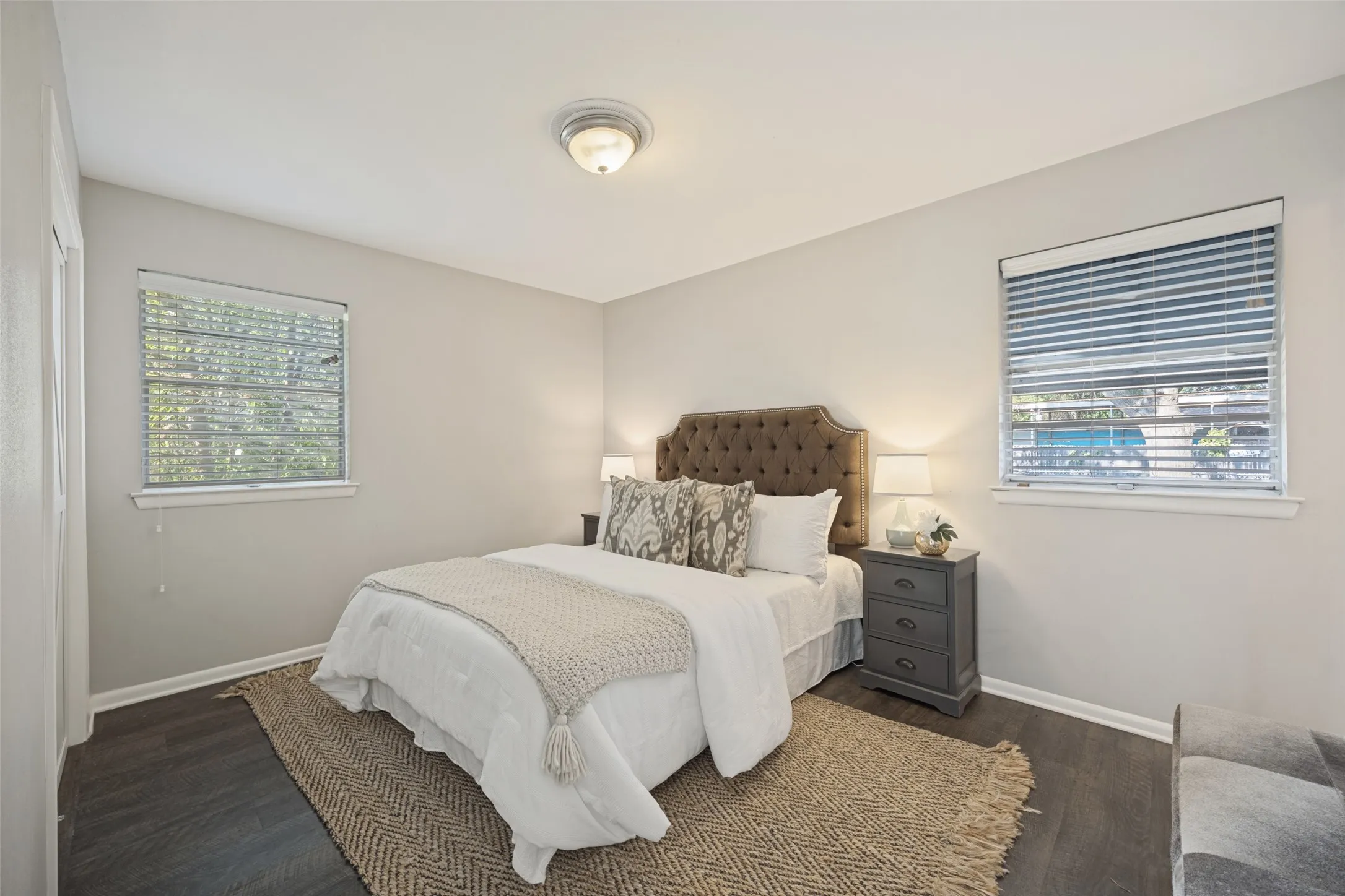 Wood-finish flooring, recessed ceiling light, and dual windows with blinds