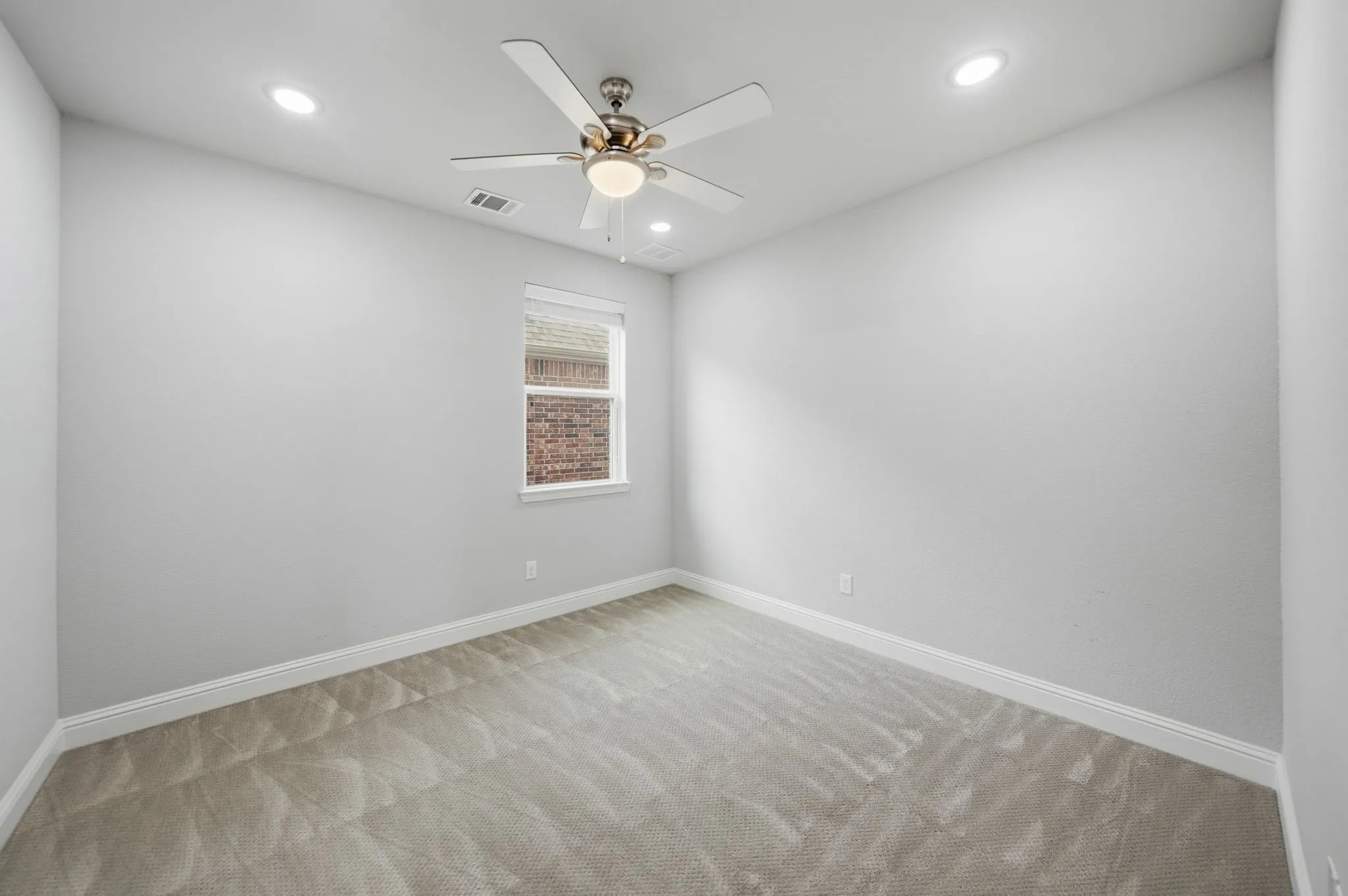 Recessed lighting, ceiling fan, white trim, single window, and light gray carpet