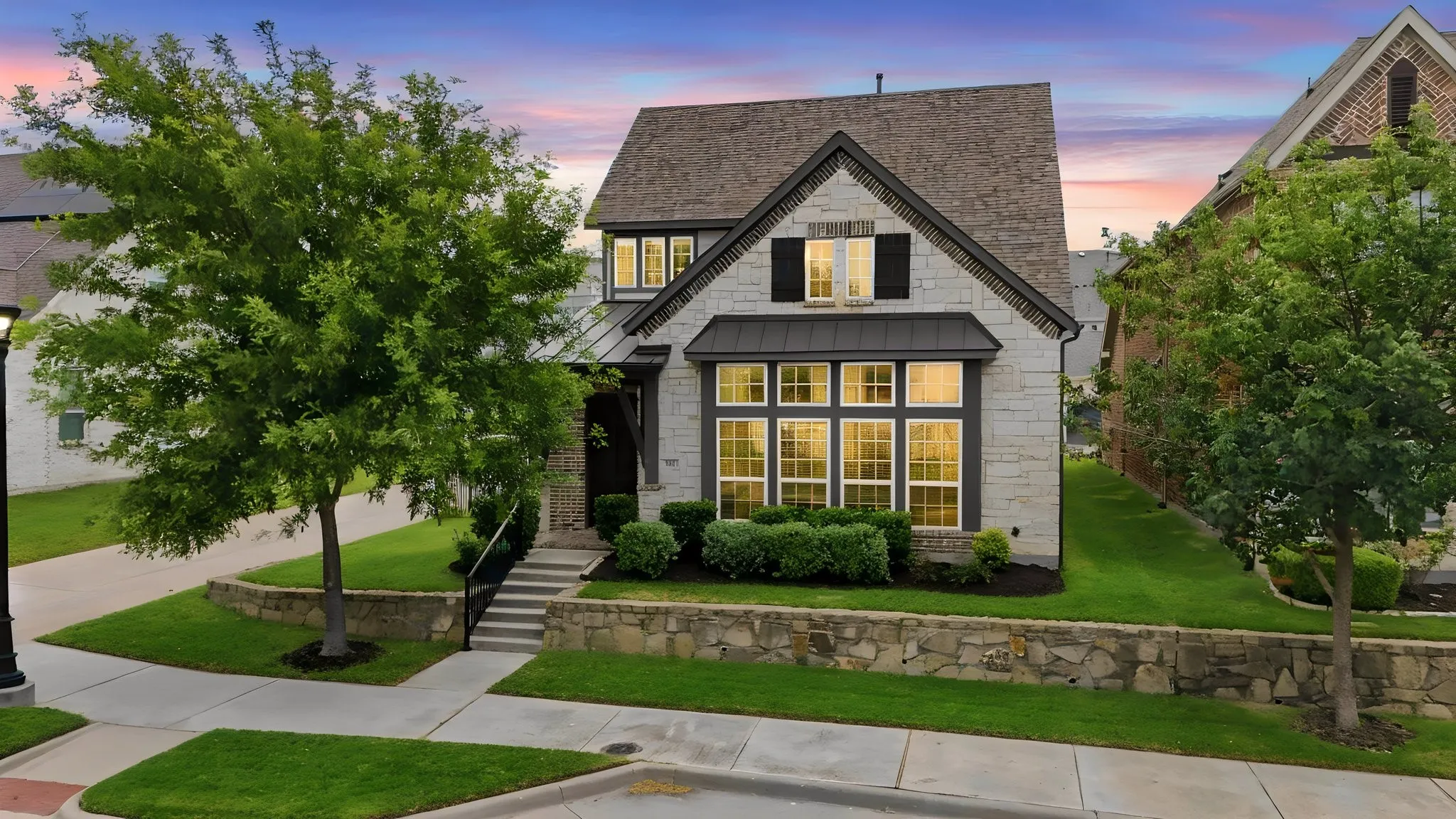 Stone facade with dark roof shingles, multi-pane windows, and black window shutters