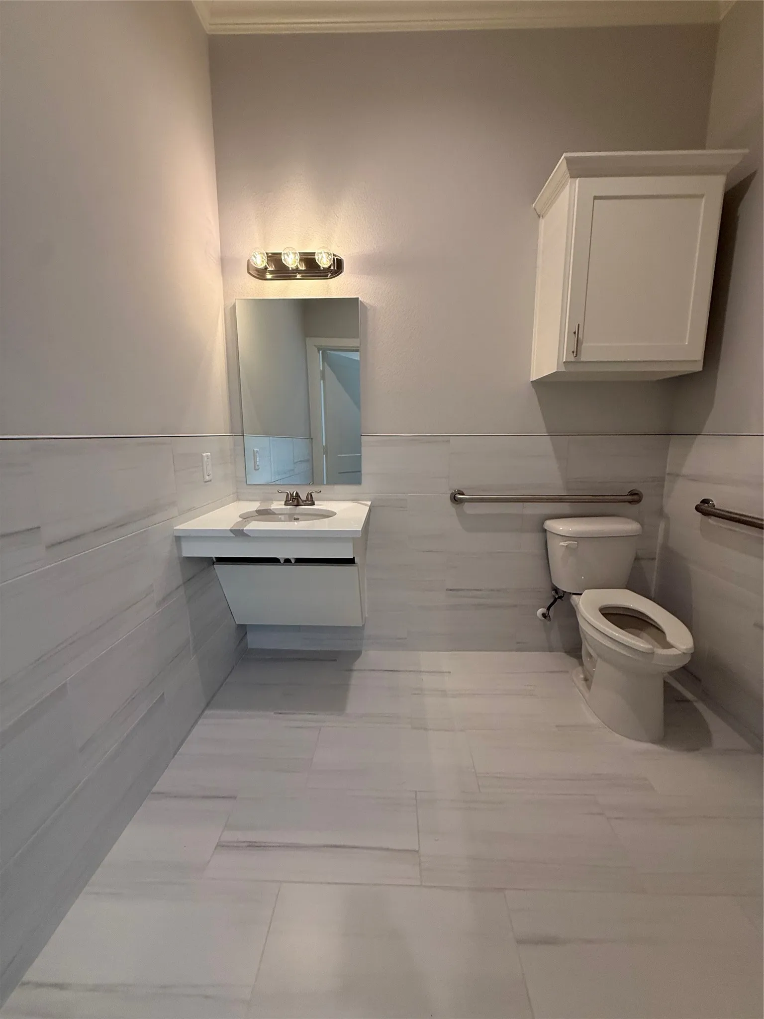 Floating vanity with a rectangular sink and chrome faucet