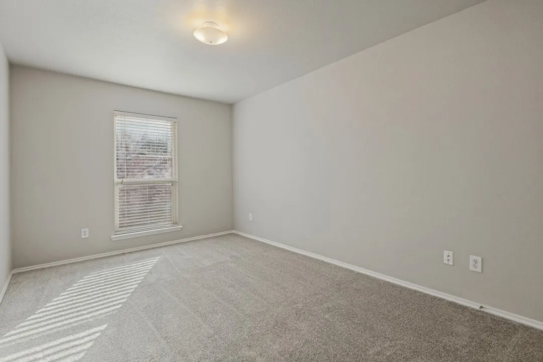 Neutral-toned walls complement plush carpeting