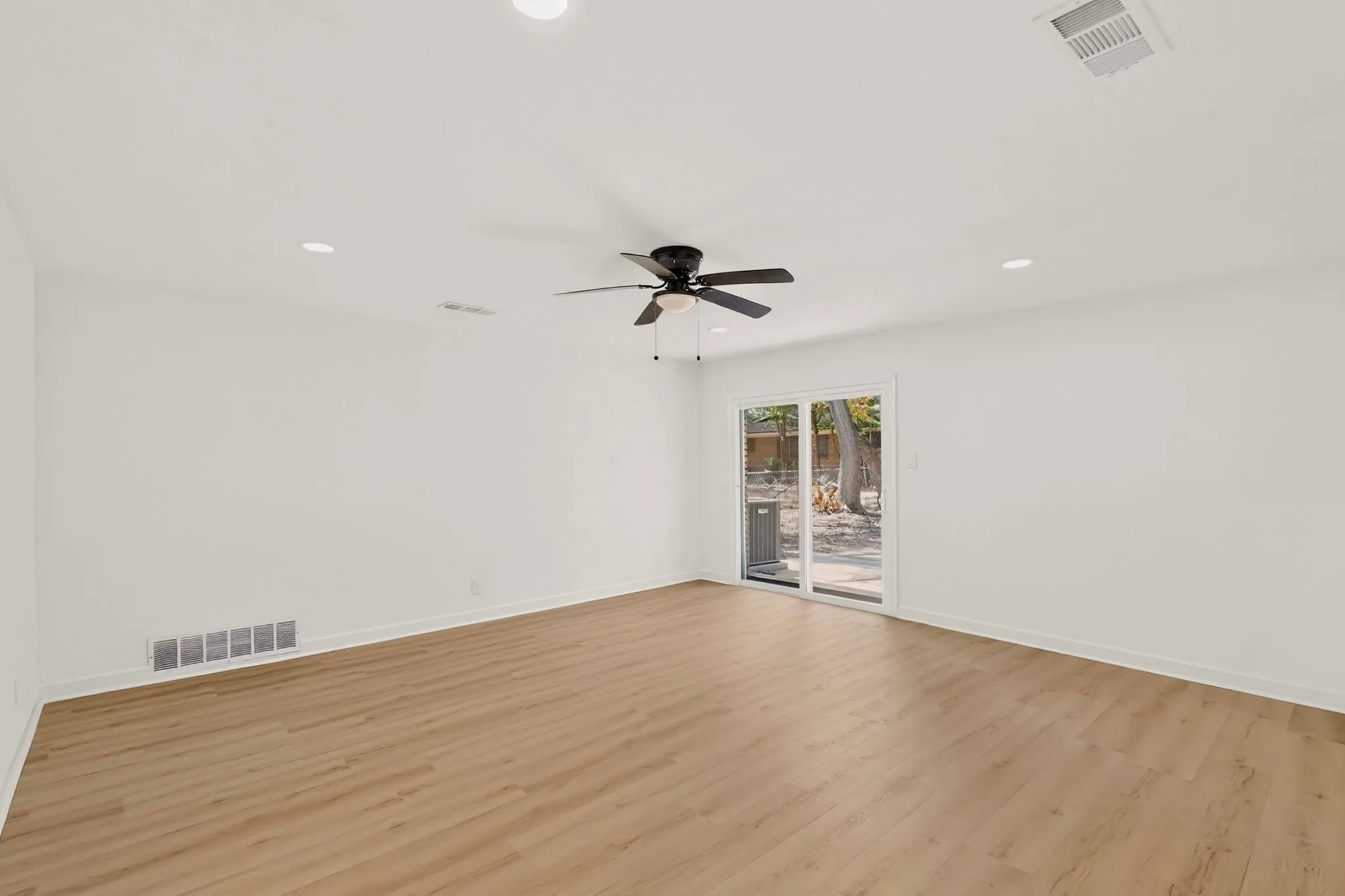 Wood-finish flooring, recessed lighting, and a ceiling fan with light