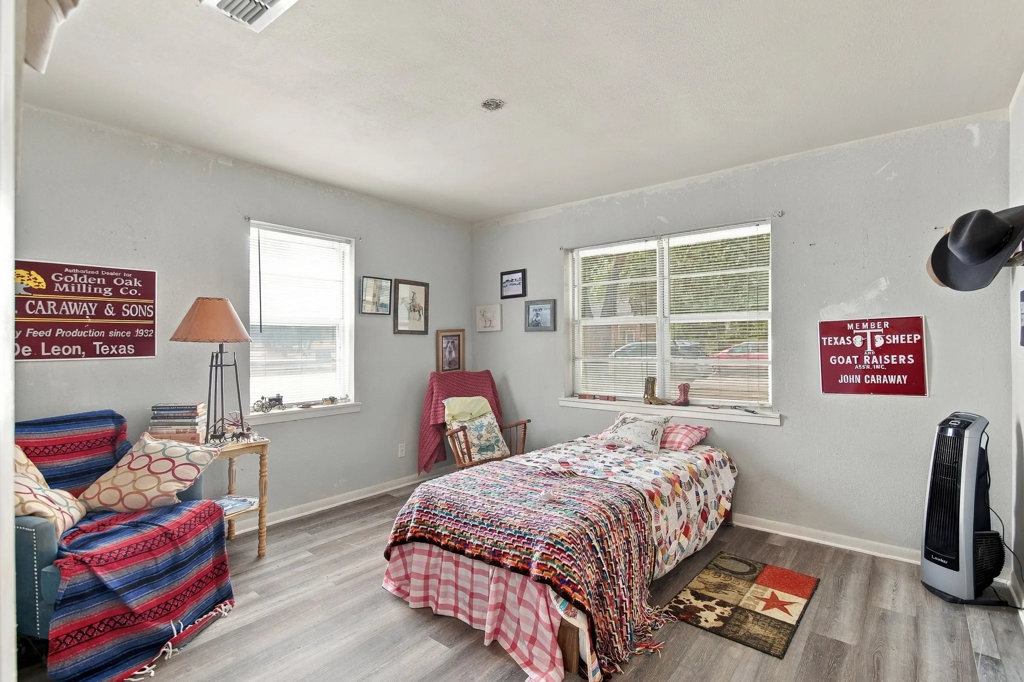 Wood-finish flooring, two windows, and light wall paint
