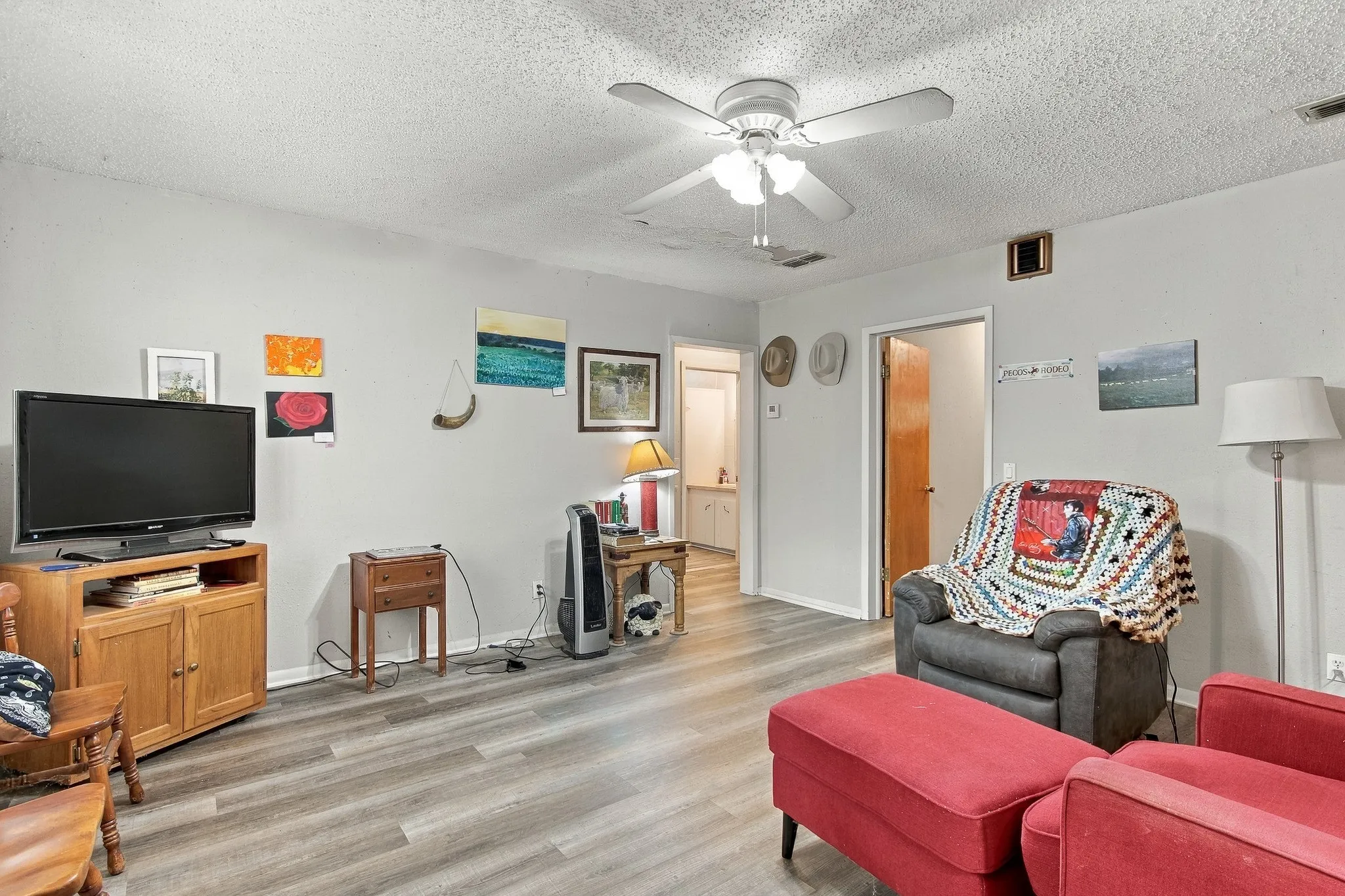 Wood-finish flooring throughout, paired with light gray walls