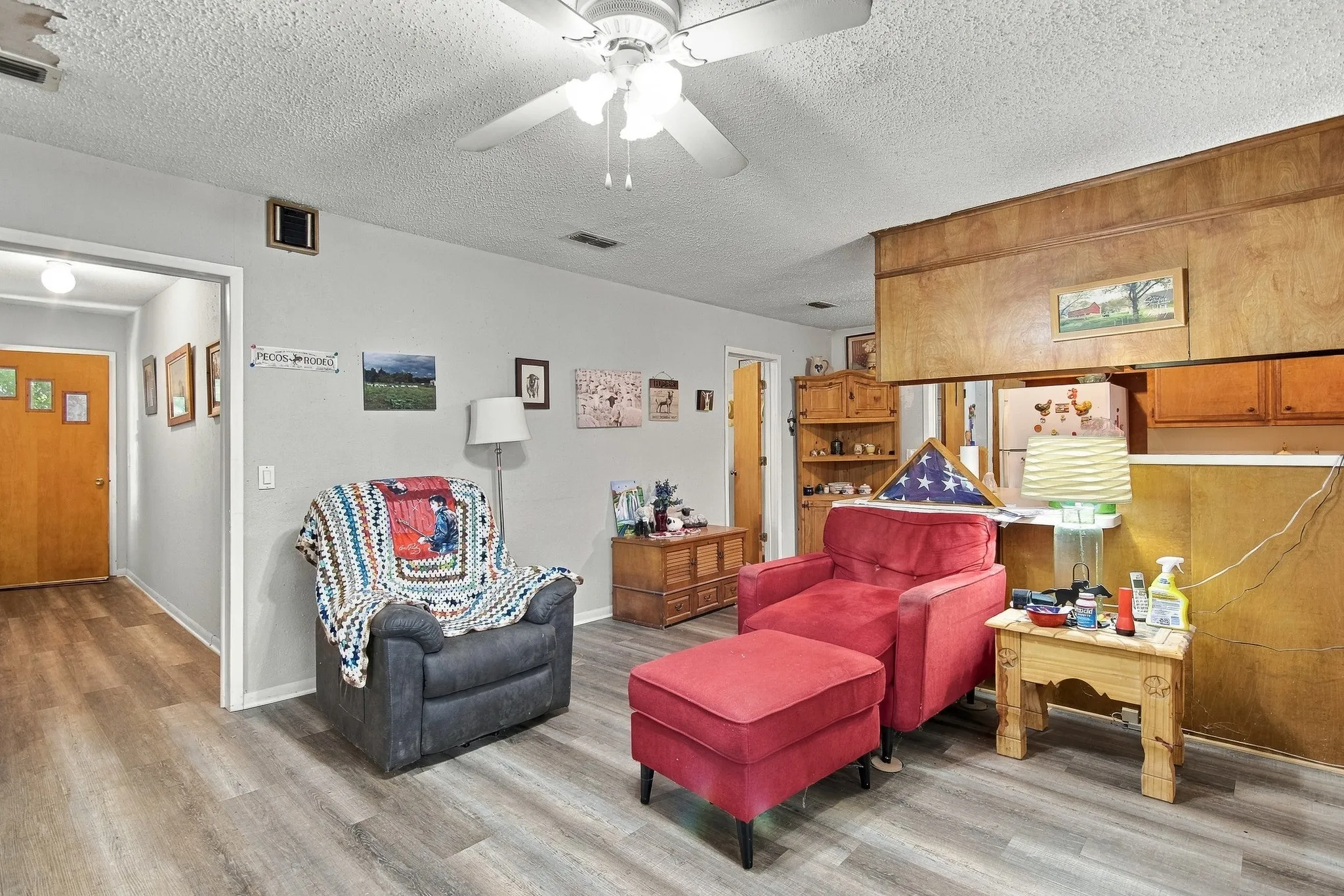 Wood-finish flooring throughout, paired with light gray wall tones and a textured ceiling