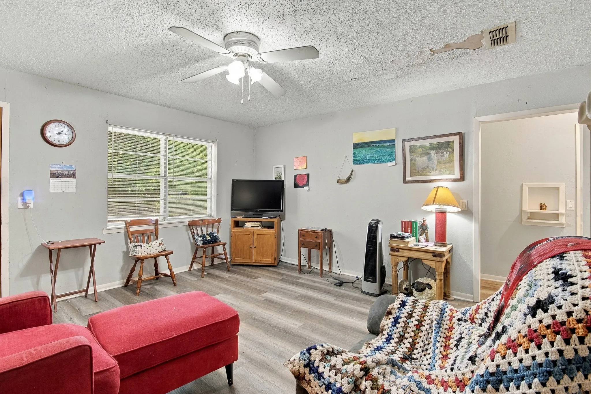 Recessed wall niche, ceiling fan, and wood-finish flooring