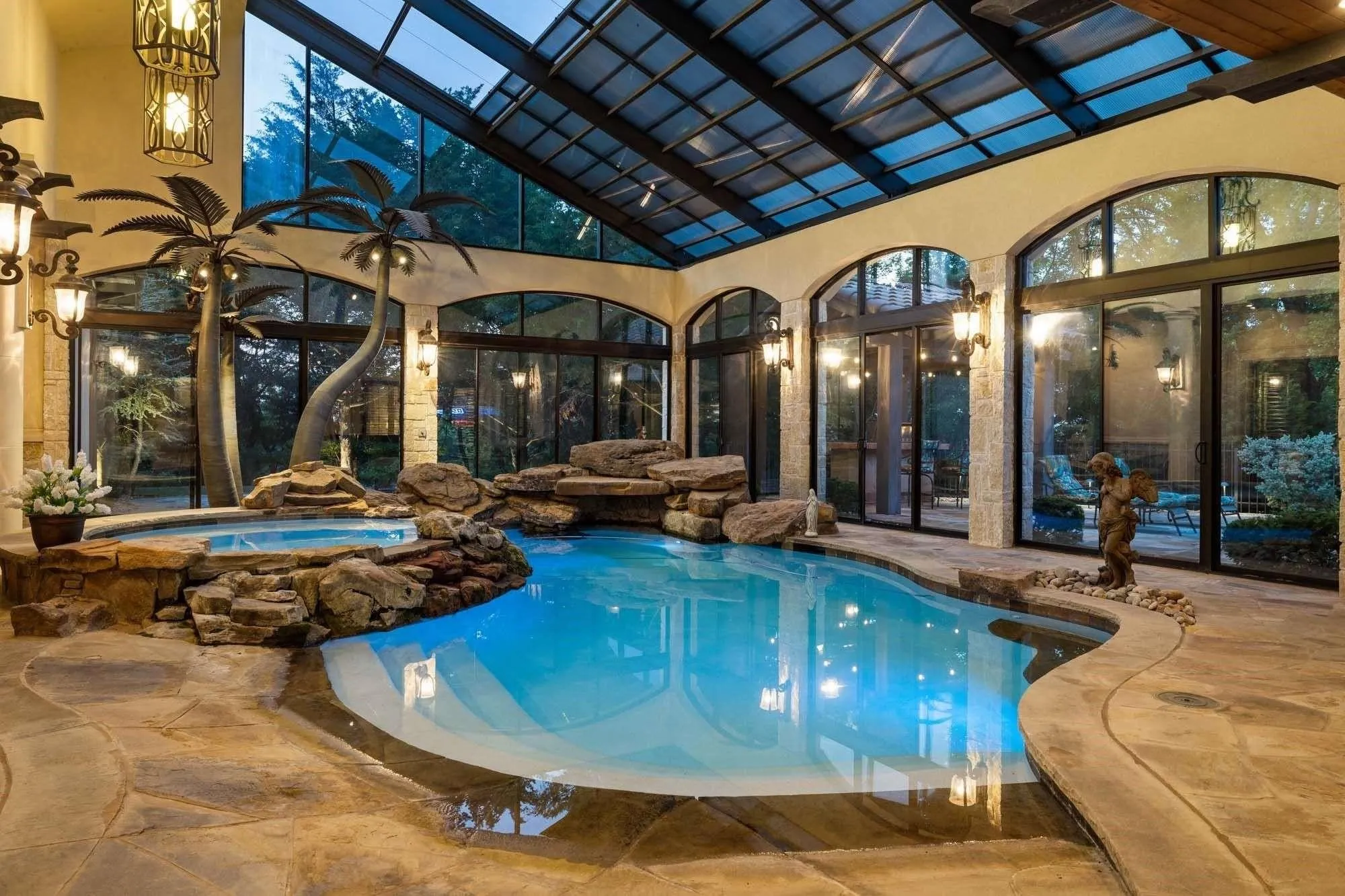 Indoor/outdoor pool with electric shades to control sun exposure